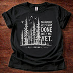 Black Christian t-shirt with forest graphic and “Thankfully, He is not done with me yet” Philippians 1:6 design