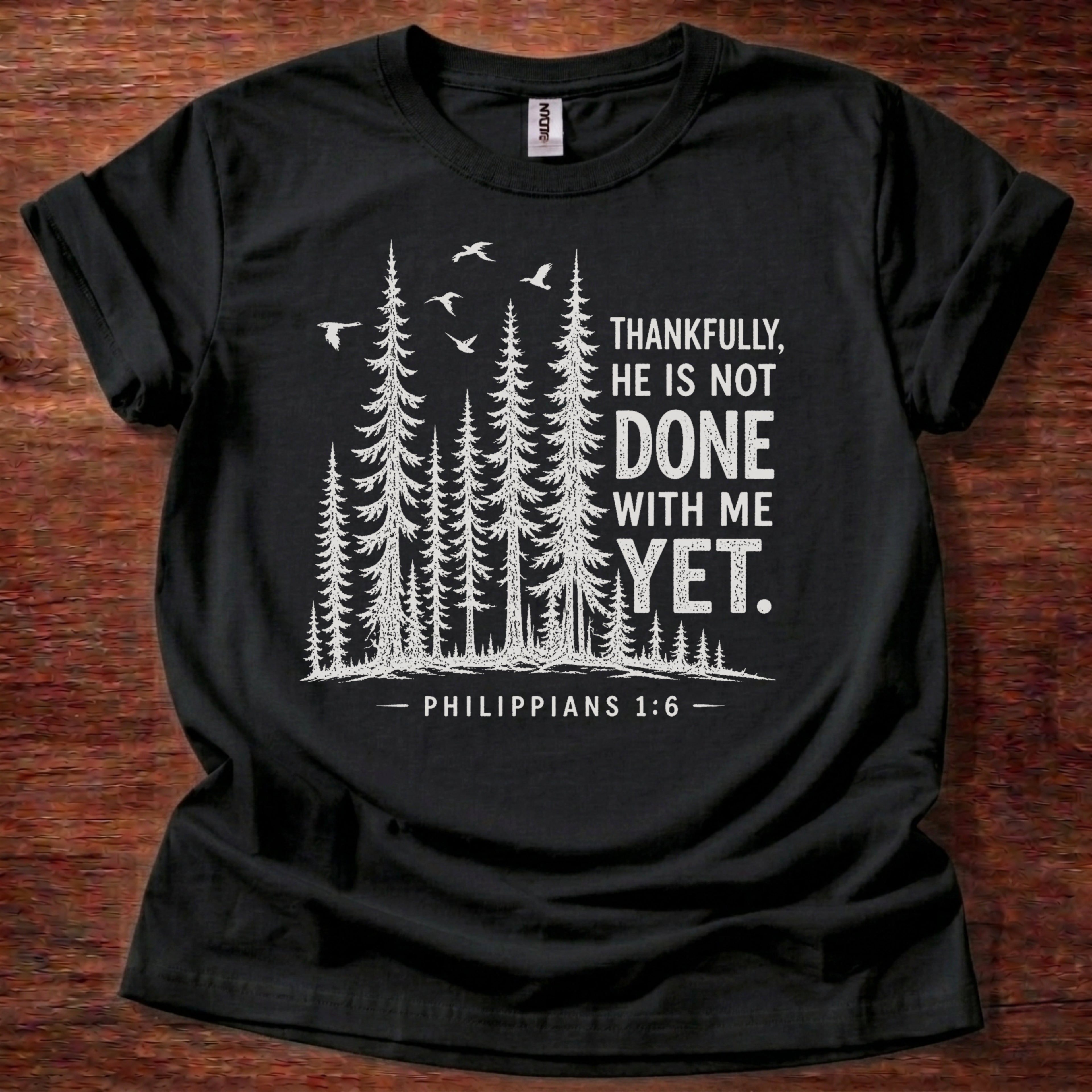 Black Christian t-shirt with forest graphic and “Thankfully, He is not done with me yet” Philippians 1:6 design
