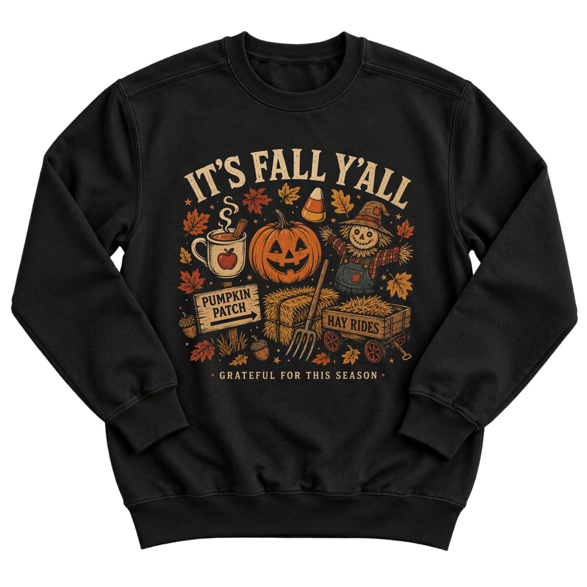 Black crewneck sweatshirt with a vintage autumn illustration of a jack-o'-lantern, scarecrow, hay bales, pumpkin patch sign, and apple cider with the words It's Fall Y'all and Grateful For This Season