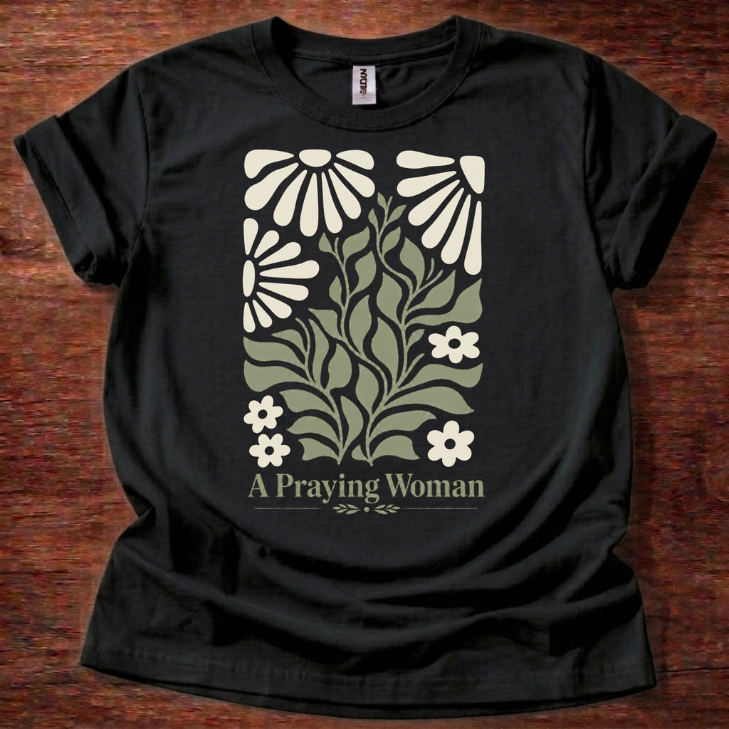 Black t-shirt featuring a floral design with the phrase “A Praying Woman” printed on the front