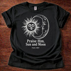 Black t-shirt featuring a sun and moon celestial design with the text “Praise Him, Sun and Moon Psalm 148:3” printed on the front