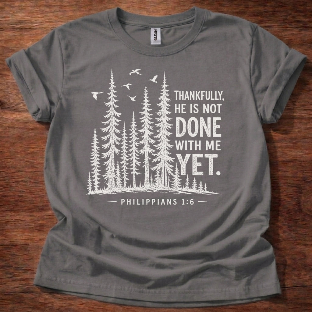 Charcoal Christian t-shirt with forest graphic and “Thankfully, He is not done with me yet” Philippians 1:6 design