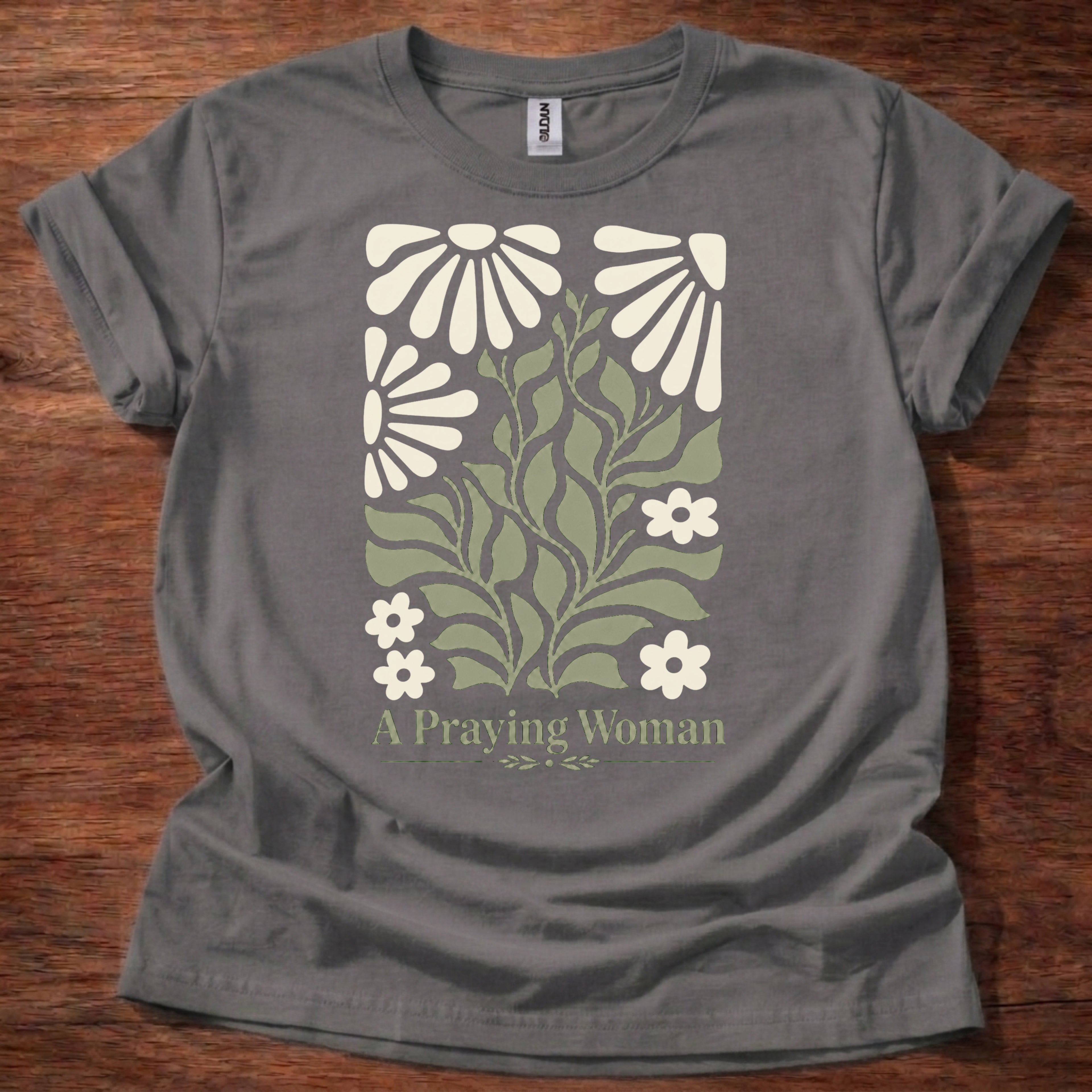 Charcoal t-shirt featuring a floral design with the phrase “A Praying Woman” printed on the front
