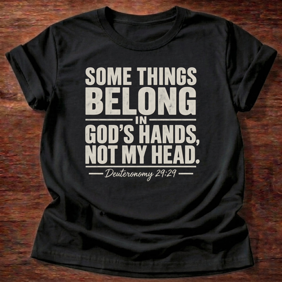 Black t-shirt printed with 'Some things belong in God's hands, not my head,' a Deuteronomy 29:29 faith based gift