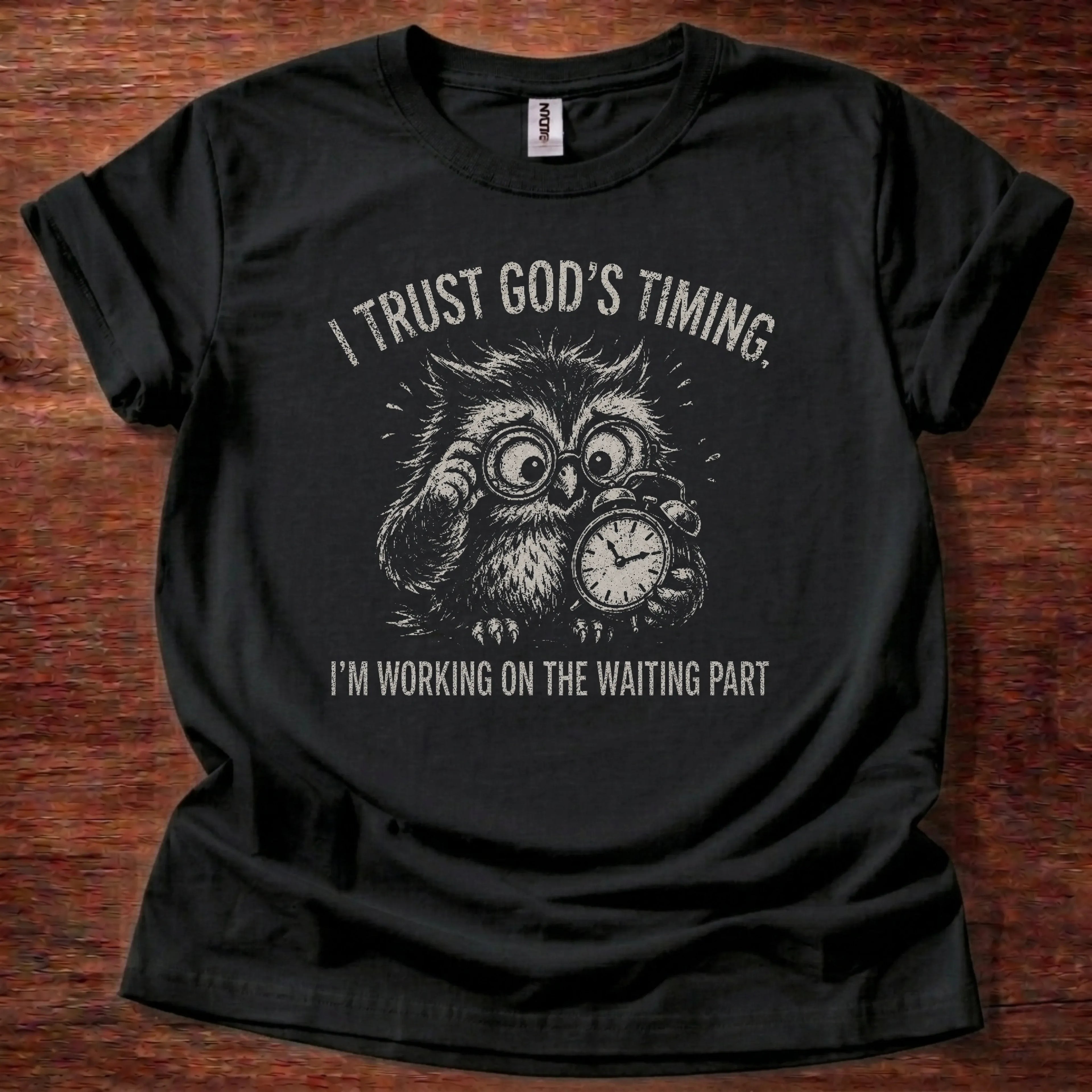 White fine-line owl illustration with clock imagery t-shirt with the text 'I Trust God's Timing. I'm Working On The Waiting Part.'