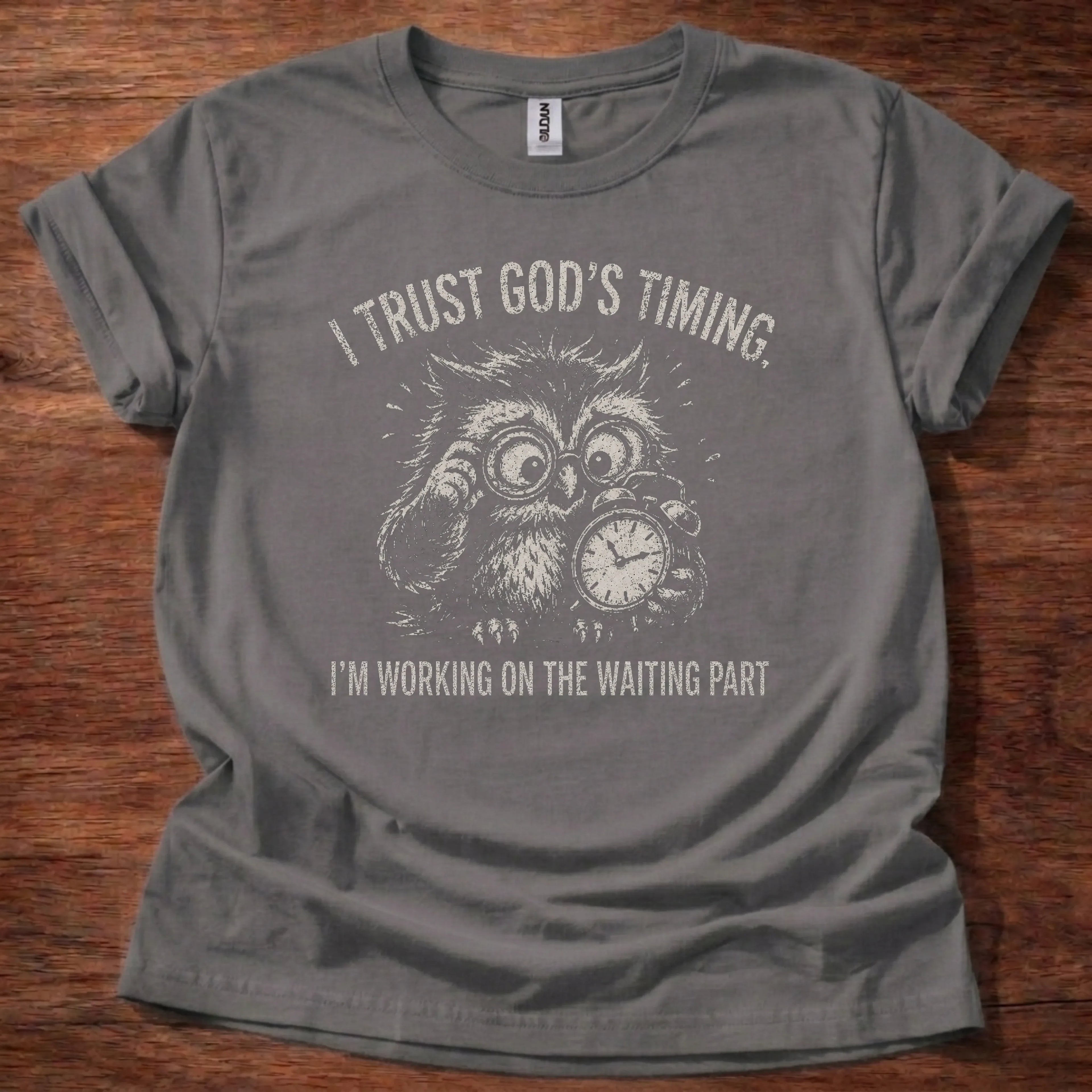 White fine-line owl illustration with clock imagery t-shirt with the text 'I Trust God's Timing. I'm Working On The Waiting Part.'