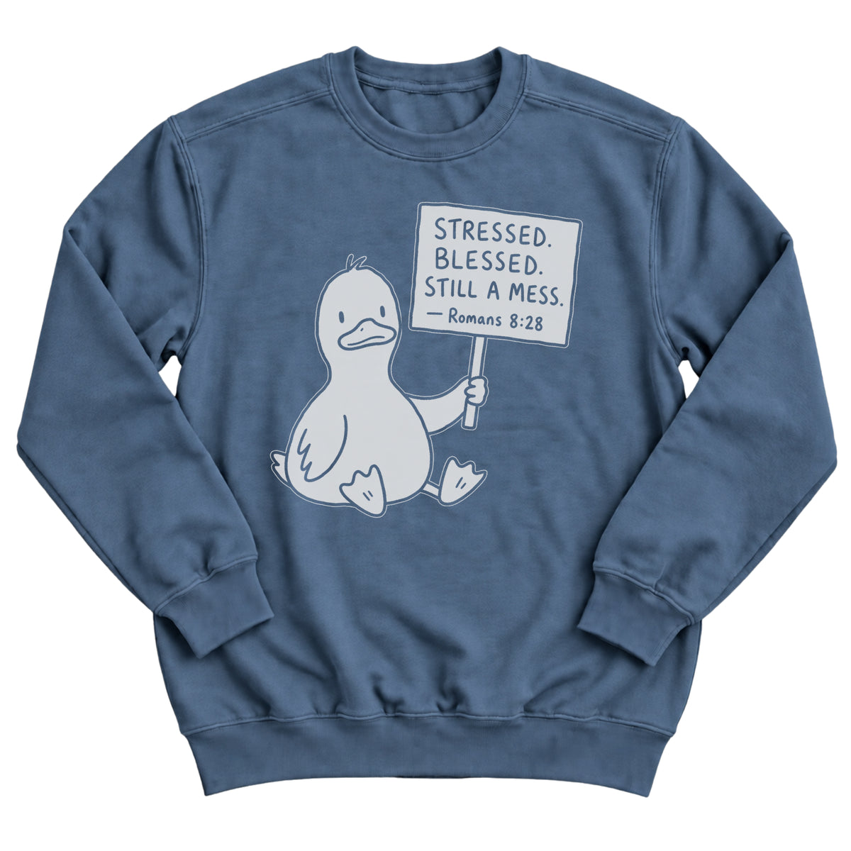 Indigo blue crewneck sweatshirt with a cartoon duck sitting and holding a sign that reads Stressed. Blessed. Still A Mess. Romans 8:28
