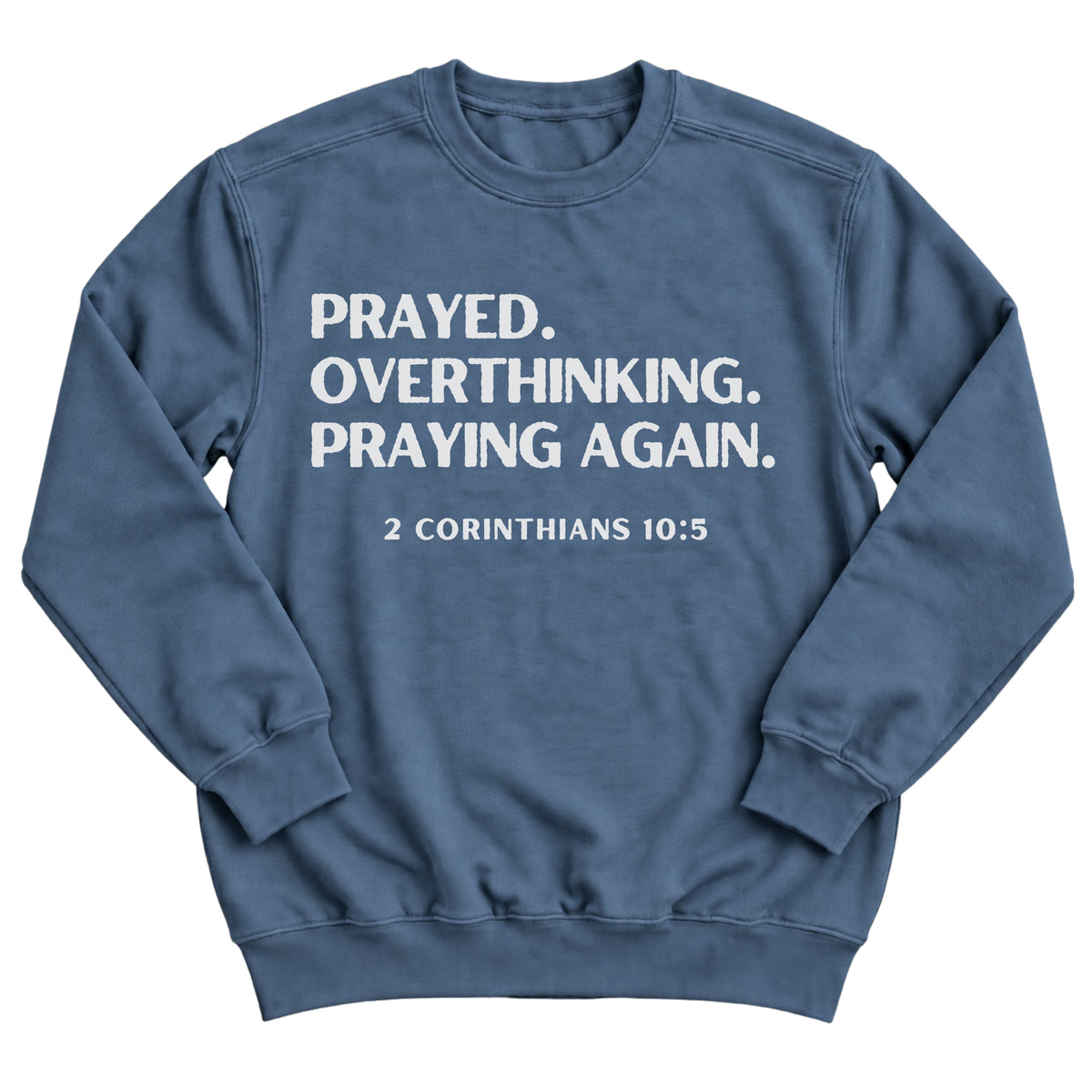 Indigo blue crewneck sweatshirt with bold stacked lettering reading Prayed. Overthinking. Praying Again. with 2 Corinthians 10:5
