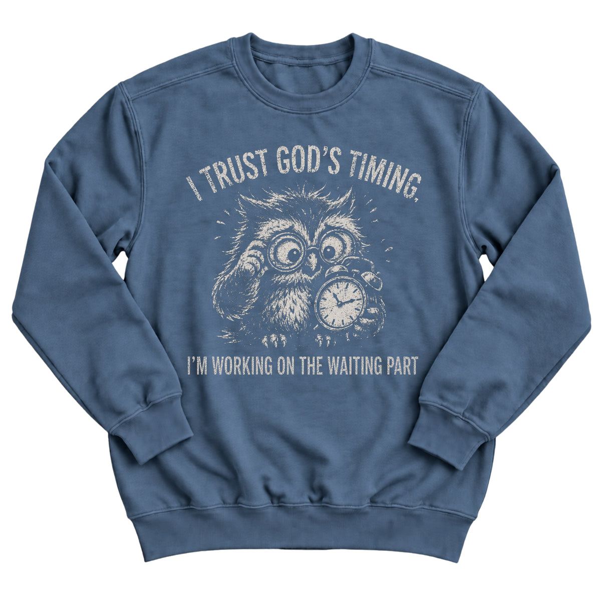 Indigo blue crewneck sweatshirt with a frazzled owl in glasses clutching a clock and the words I Trust God's Timing. I'm Working On The Waiting Part.