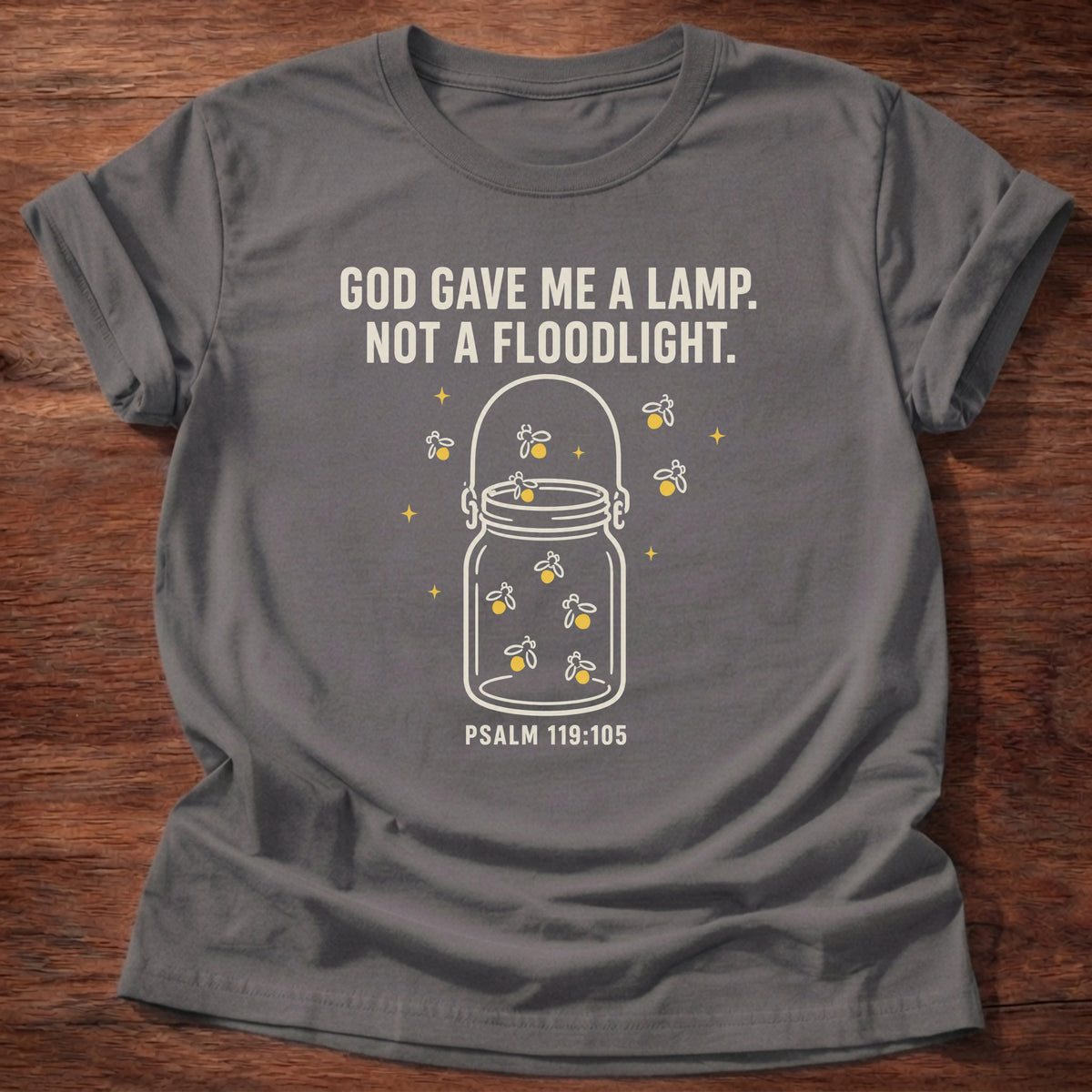 Charcoal t-shirt featuring a lit jar and 'God gave me a lamp, not a floodlight' scripture truth tee