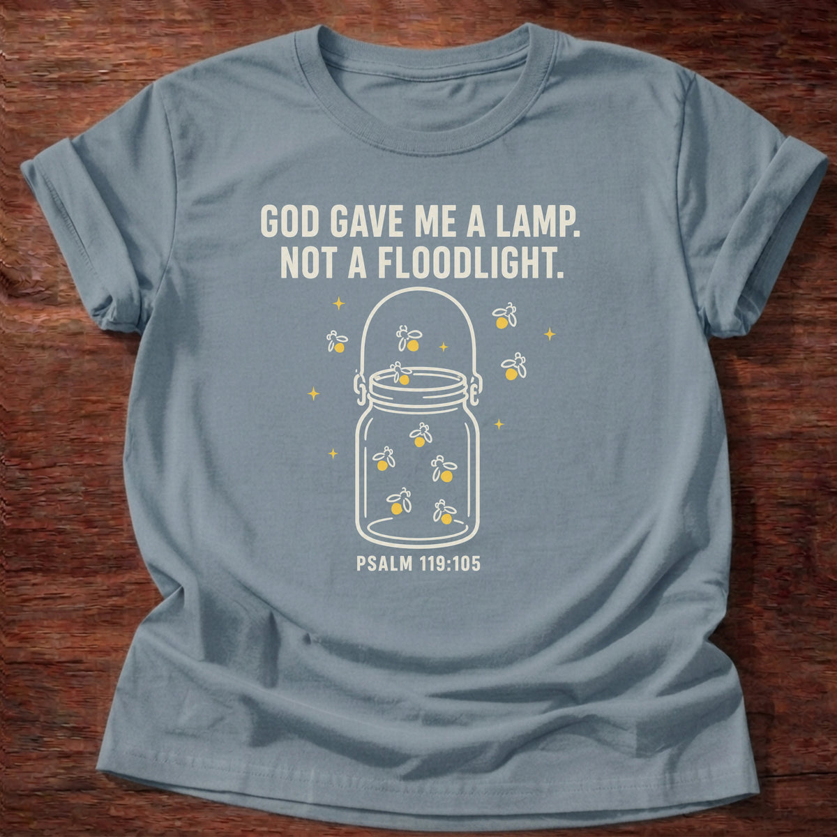 Stone blue t-shirt with a glowing jar illustration reading 'God gave me a lamp, not a floodlight' Psalm 119:105 shirt