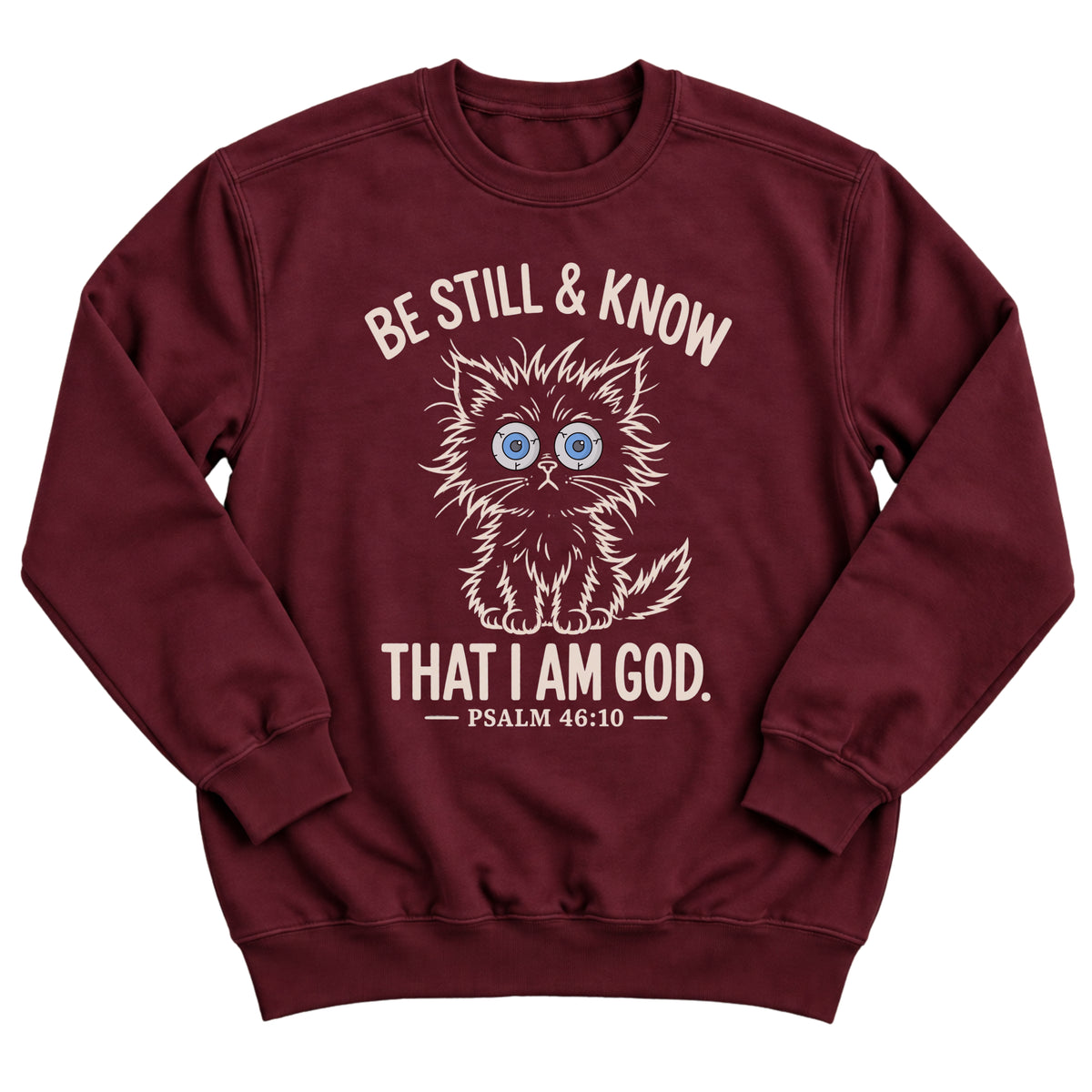 Maroon crewneck sweatshirt with a wide-eyed fluffy kitten illustration and the words Be Still & Know That I Am God, Psalm 46:10