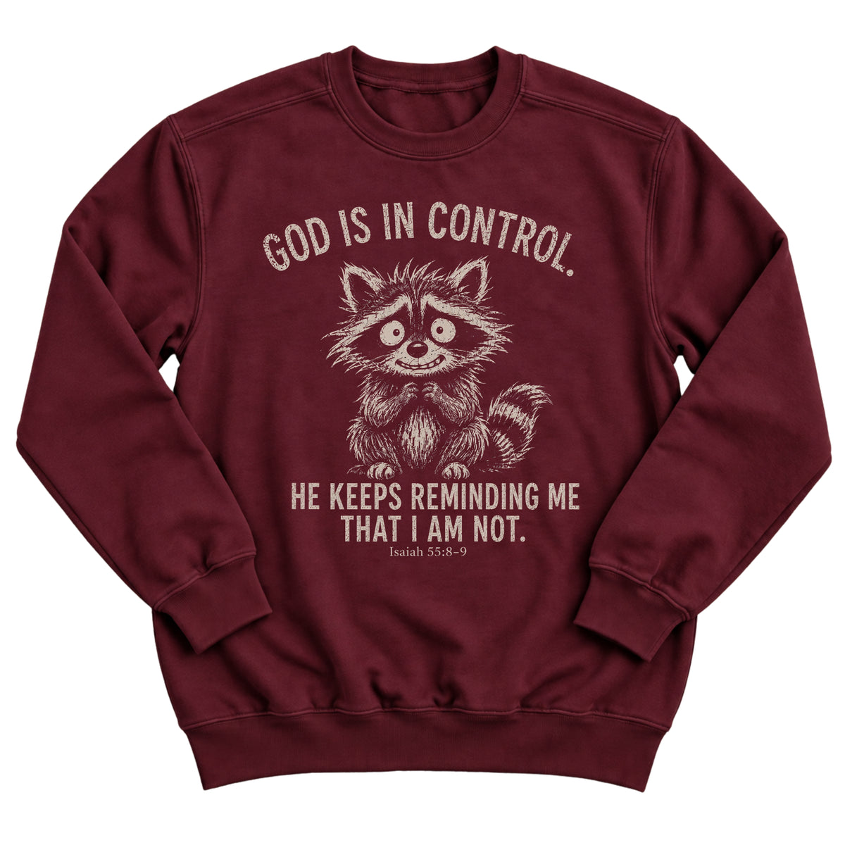 Maroon crewneck sweatshirt with a nervous, wide-eyed raccoon illustration and the words God Is In Control. He Keeps Reminding Me That I Am Not. Isaiah 55:8-9