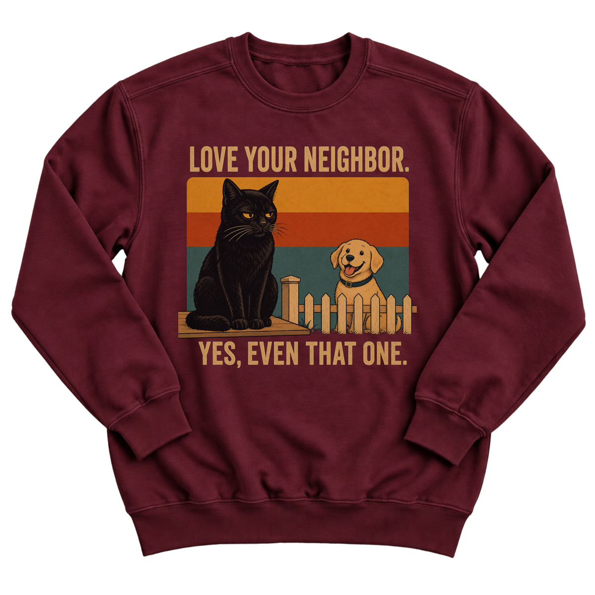 Maroon crewneck sweatshirt with a retro sunset illustration of a grumpy black cat on a fence and a happy golden retriever with the words Love Your Neighbor. Yes, Even That One.