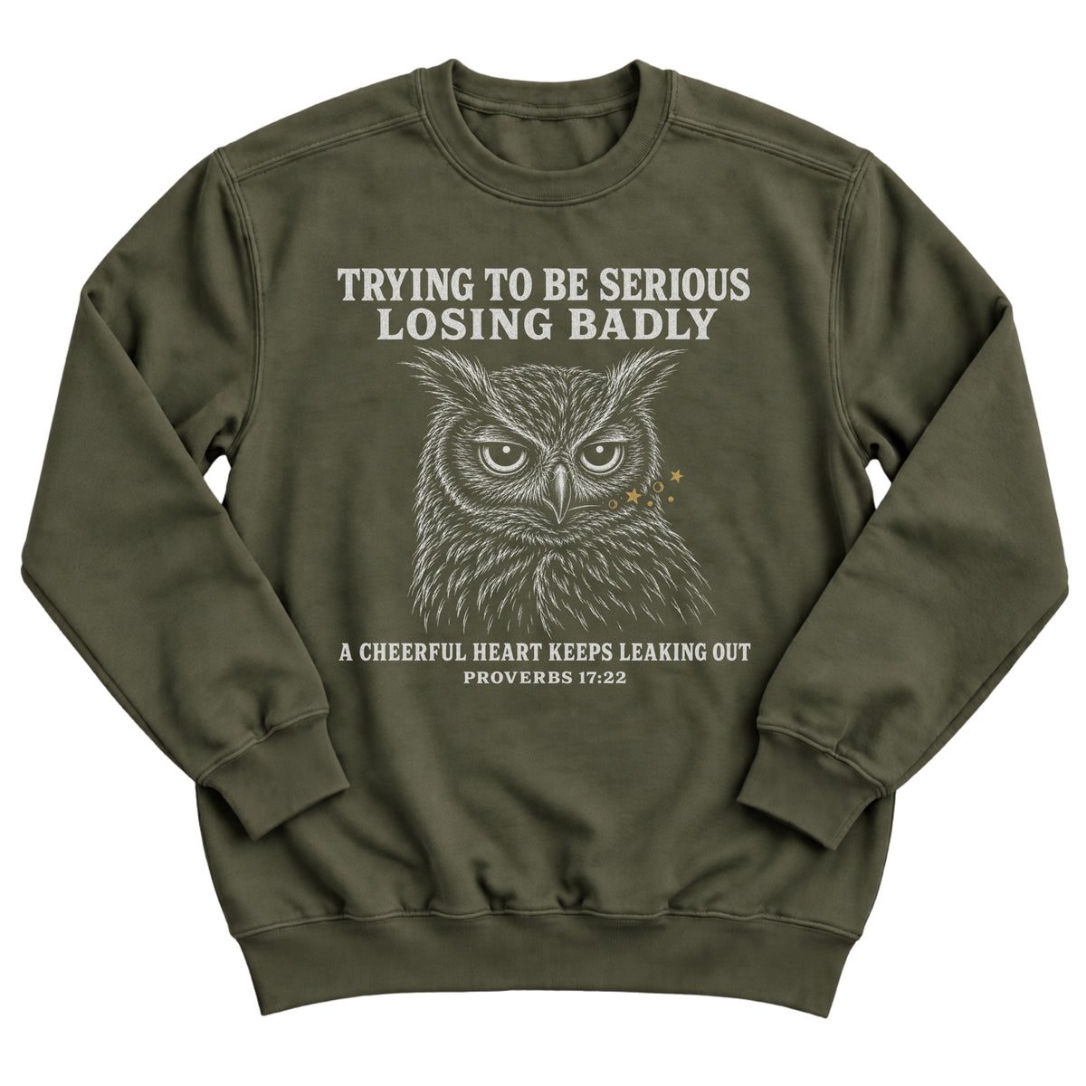 Military green crewneck sweatshirt with a detailed stern owl illustration and the words Trying To Be Serious. Losing Badly. A Cheerful Heart Keeps Leaking Out. Proverbs 17:22