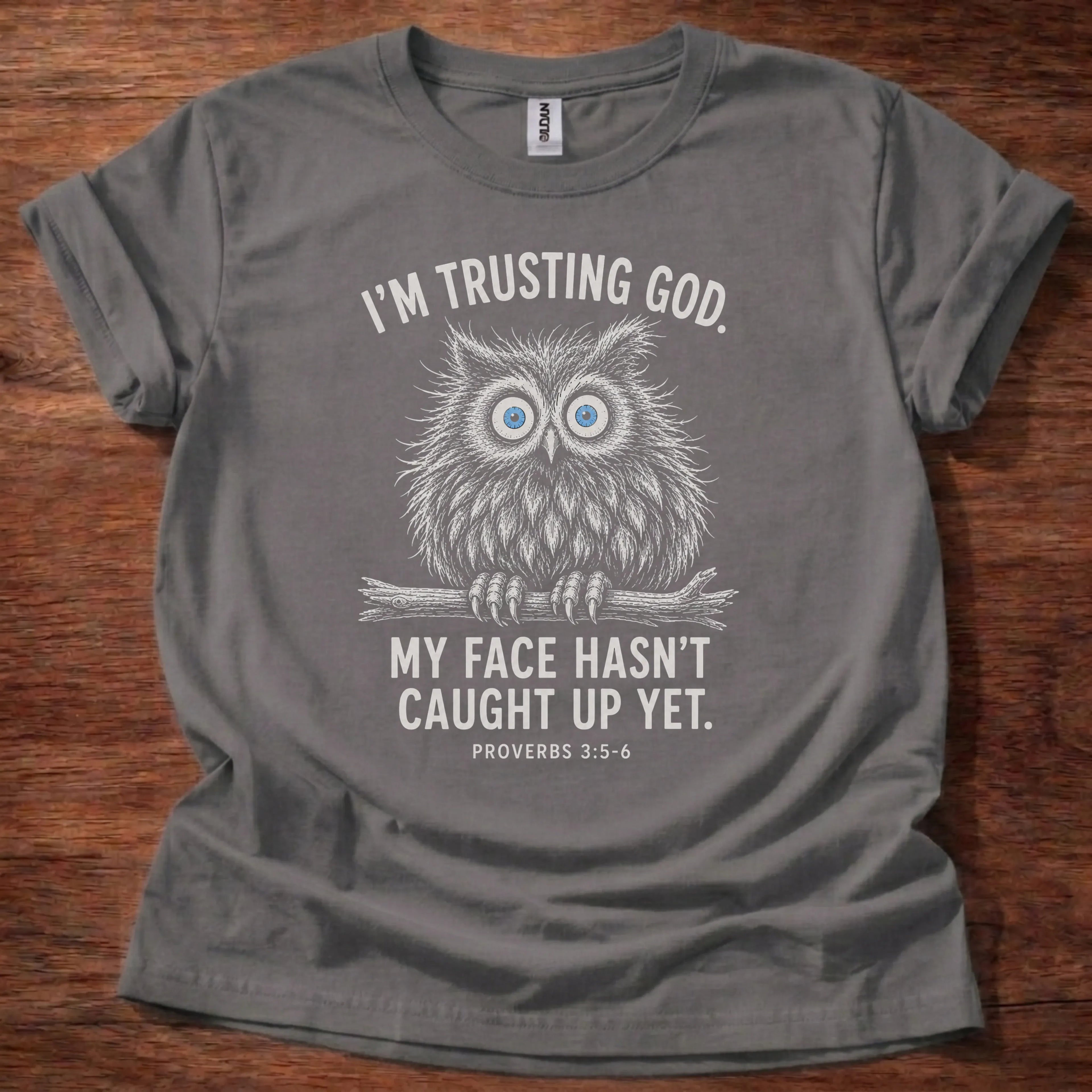 White fine-line owl illustration t-shirt with the text 'I'm Trusting God. My Face Hasn't Caught Up Yet.' and Proverbs 3:5-6