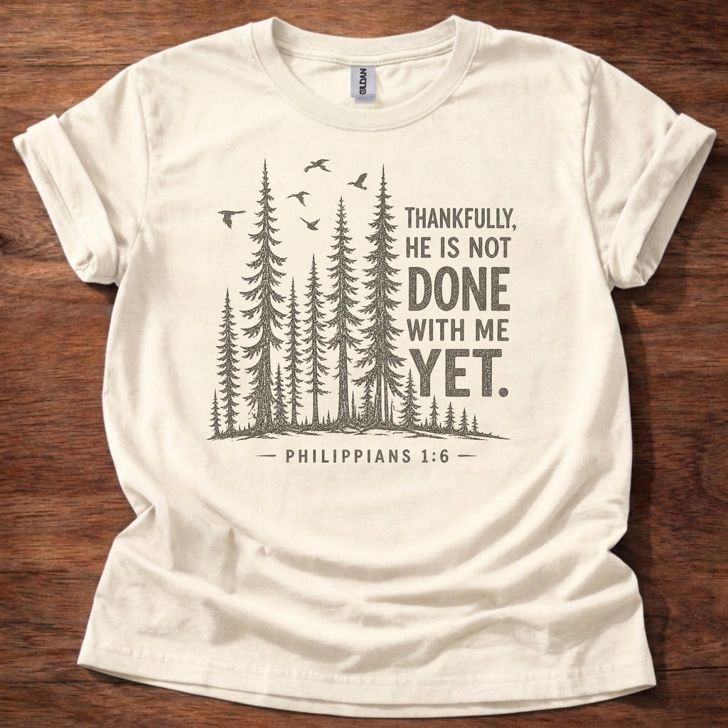 Natural Christian t-shirt with forest graphic and “Thankfully, He is not done with me yet” Philippians 1:6 design