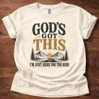 Natural God’s Got This I’m Just Here for the Ride Christian shirt with mountain and sunrise graphic on beige t-shirt, inspirational faith design