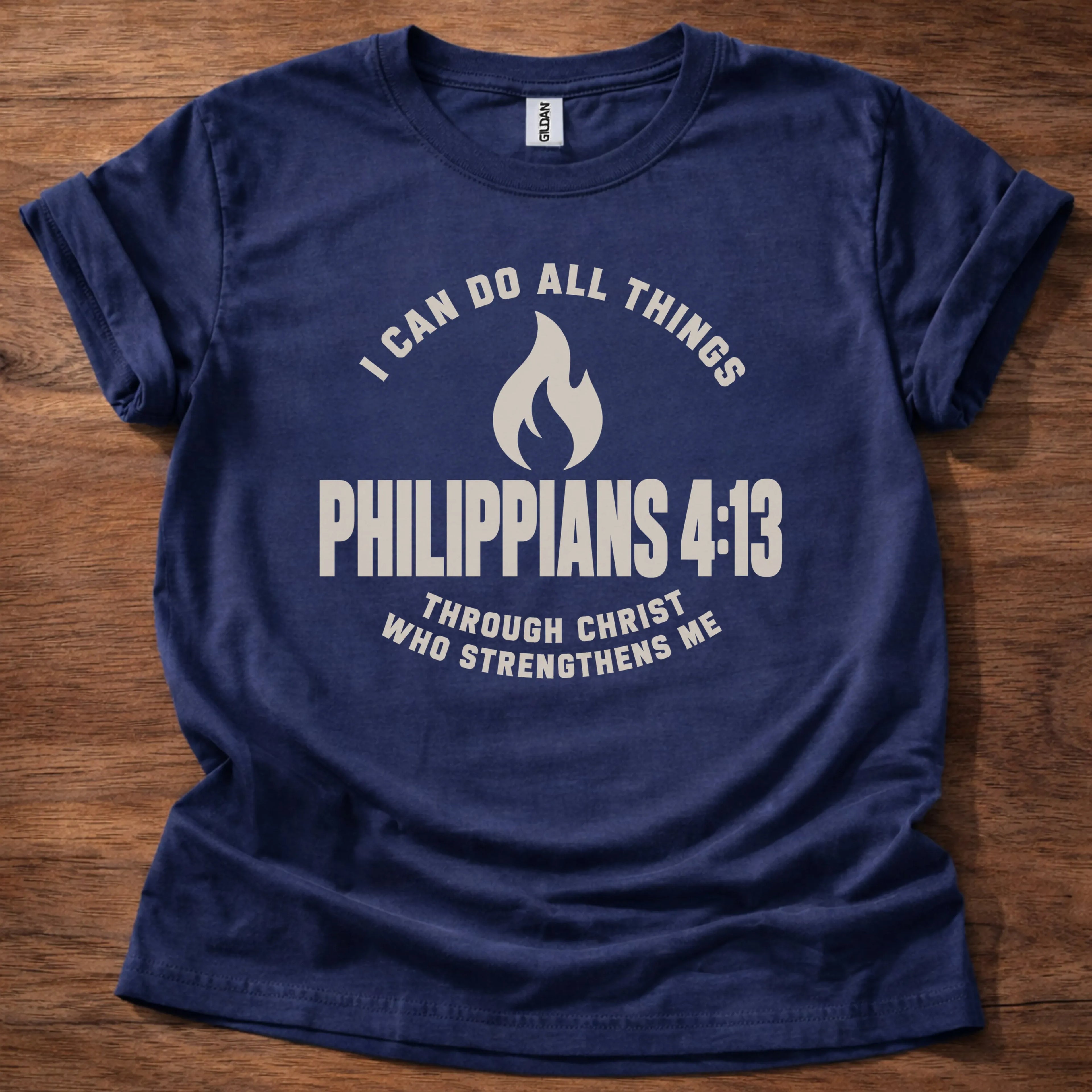 Cream flame icon t-shirt with the text 'I Can Do All Things' arched above and 'Philippians 4:13' below