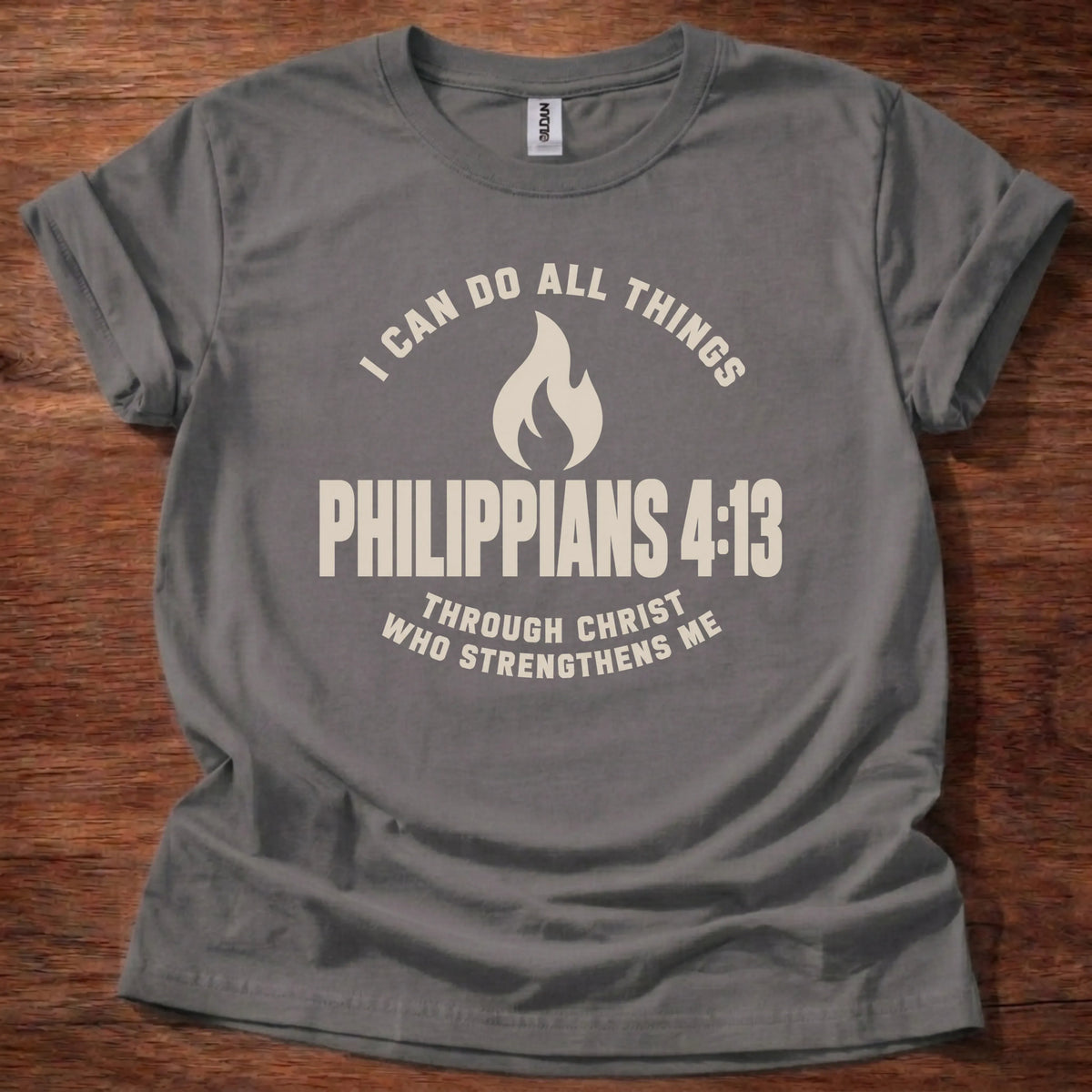 Cream flame icon t-shirt with the text 'I Can Do All Things' arched above and 'Philippians 4:13' below