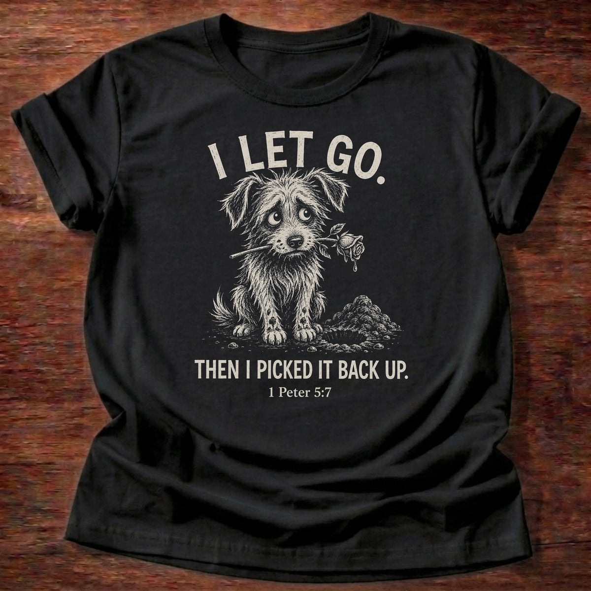 Black t-shirt printed with a raccoon and 'I let go. Then I picked it back up.' quote, a relatable faith based gift