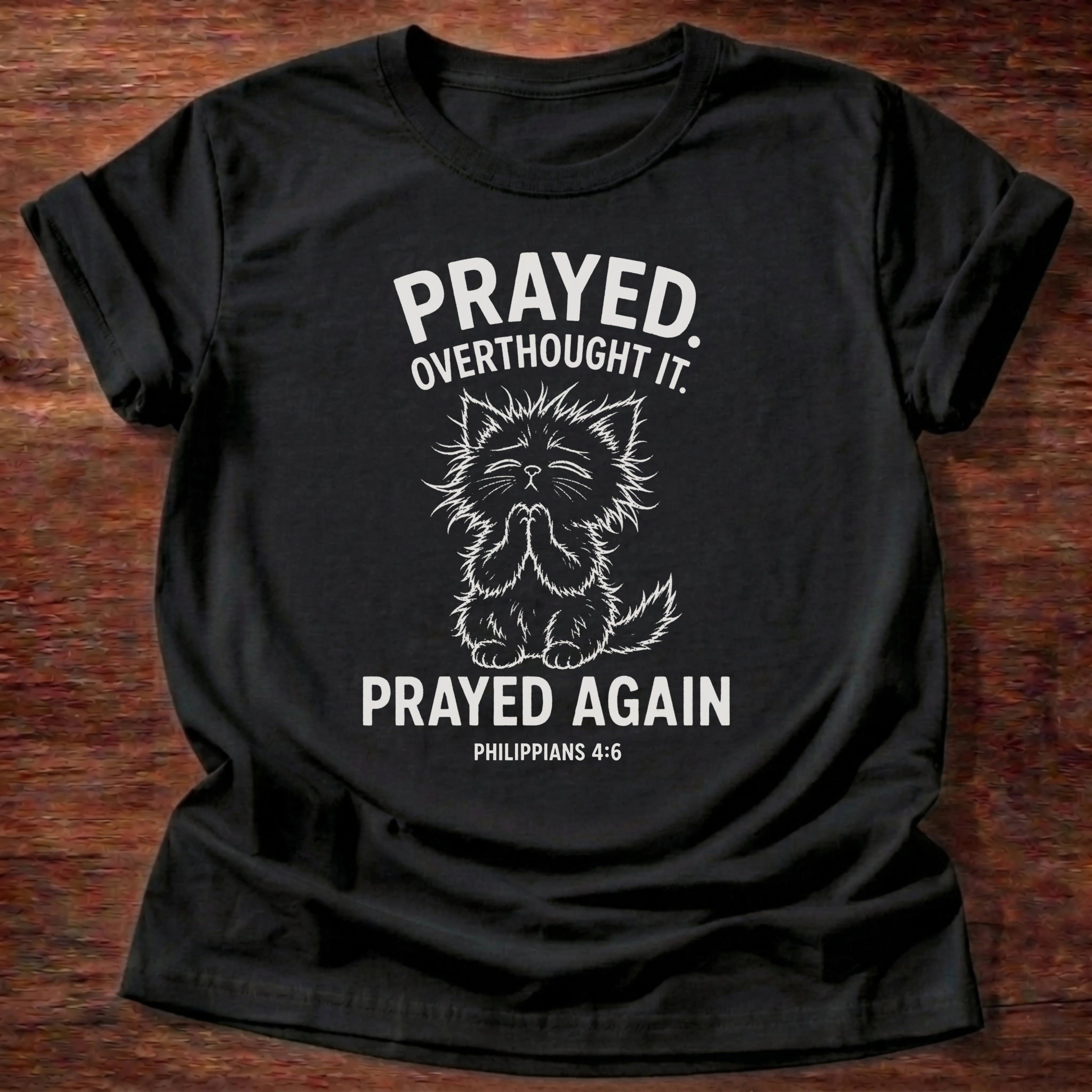 Black t-shirt printed with raccoon graphic and 'Prayed. Overthought it. Prayed again.' a Philippians 4:6 faith based gift