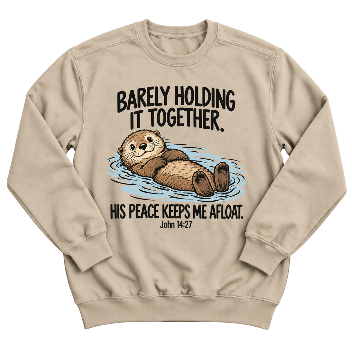 Sand crewneck sweatshirt with a smiling otter floating on its back in the water with the words Barely Holding It Together. His Peace Keeps Me Afloat. John 14:27