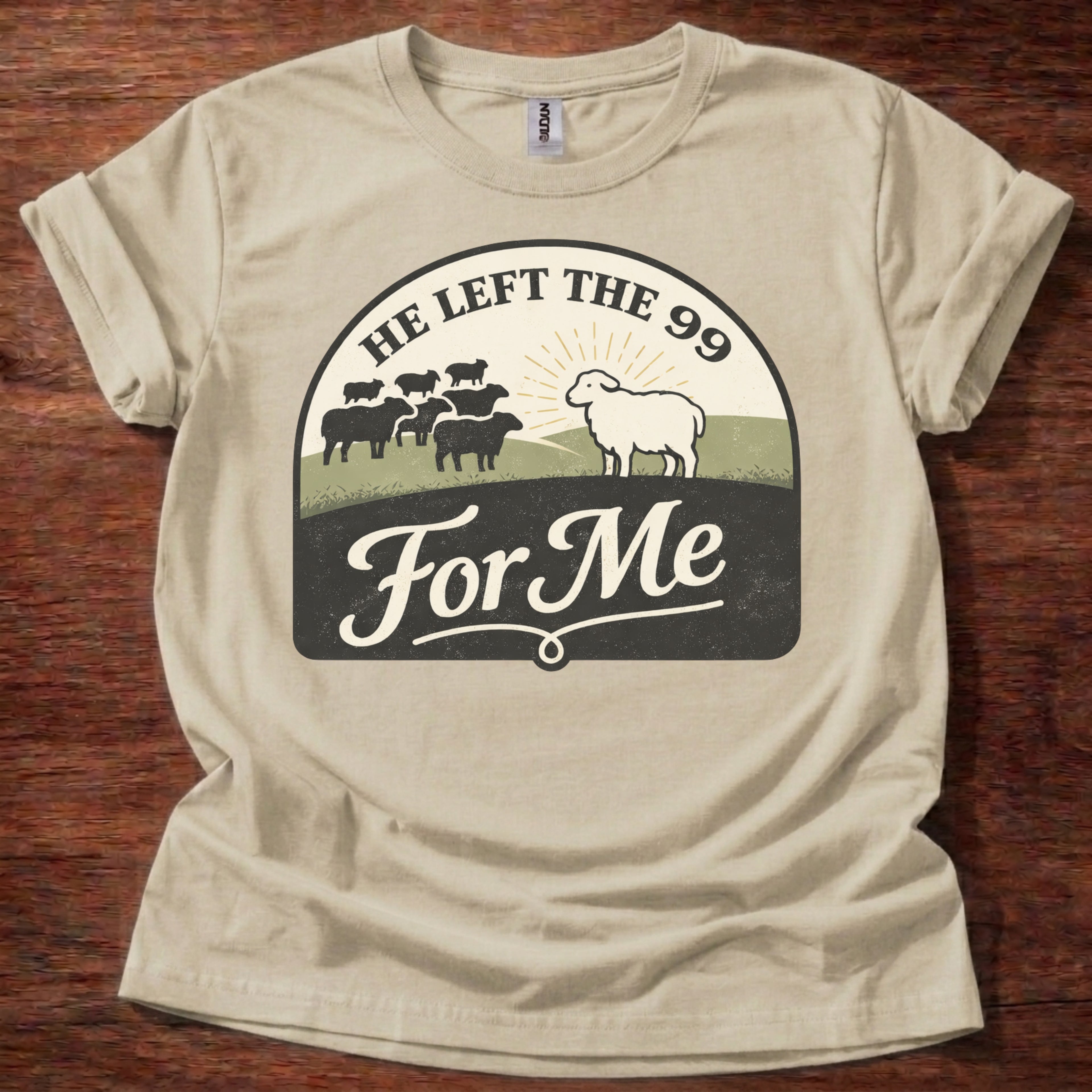 Beige t-shirt with graphic design featuring sheep on a wooden surface