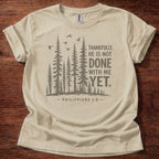 Sand Christian t-shirt with forest graphic and “Thankfully, He is not done with me yet” Philippians 1:6 design
