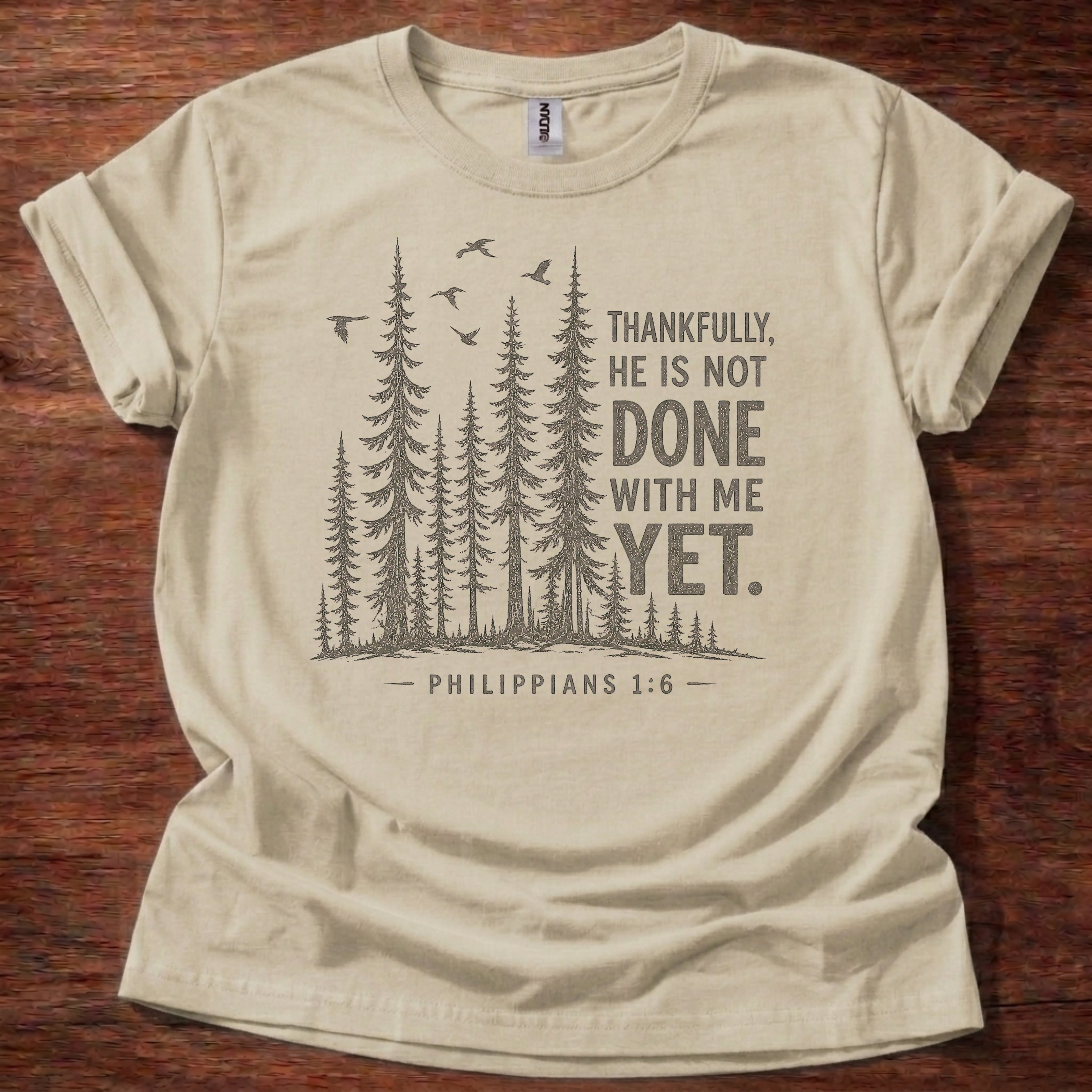 Sand Christian t-shirt with forest graphic and “Thankfully, He is not done with me yet” Philippians 1:6 design