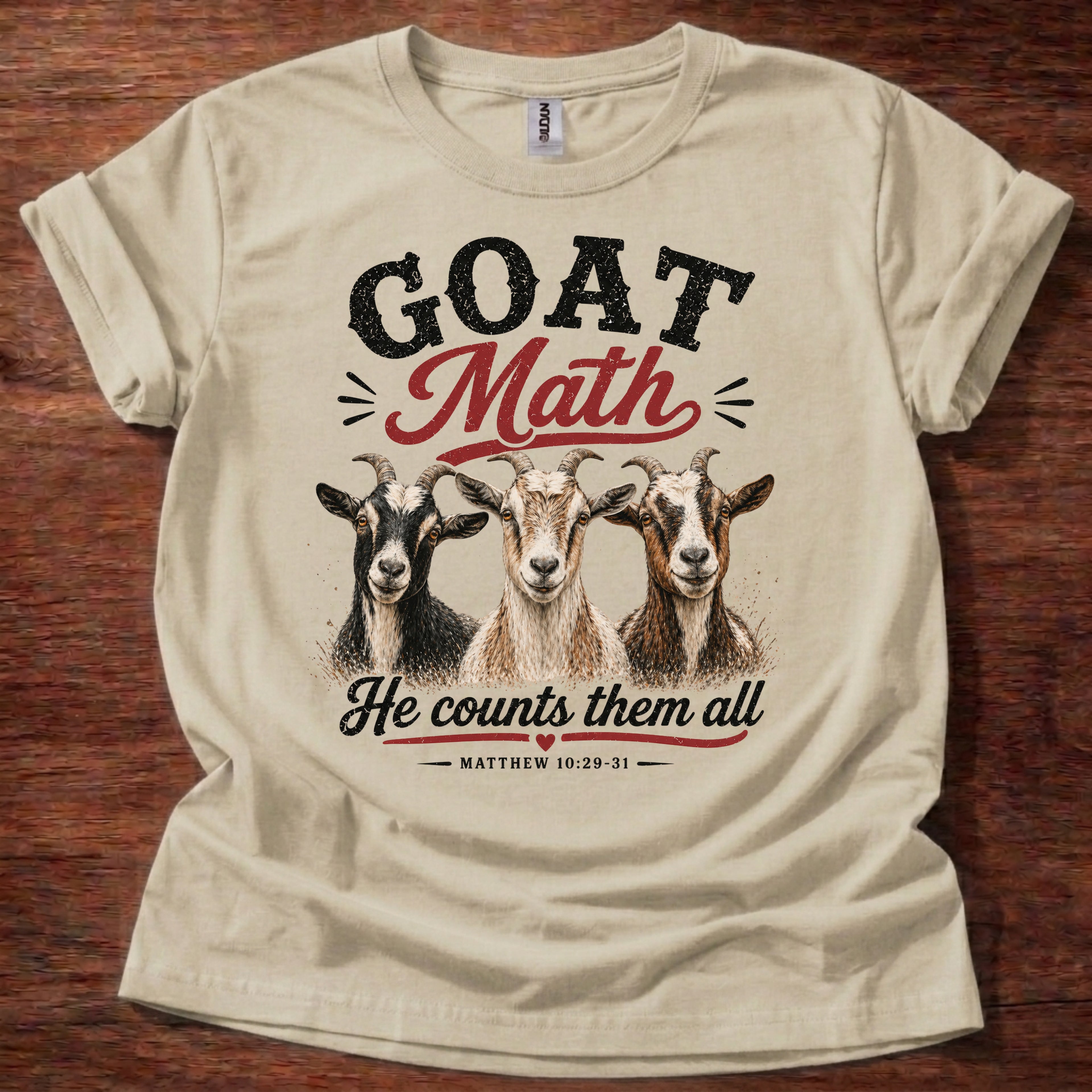Sand Goat Math He Counts Them All Christian goat shirt with three goats graphic on beige t-shirt, Matthew 10:29-31 Bible verse design