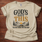 Sand God’s Got This I’m Just Here for the Ride Christian shirt with mountain and sunrise graphic on beige t-shirt, inspirational faith design