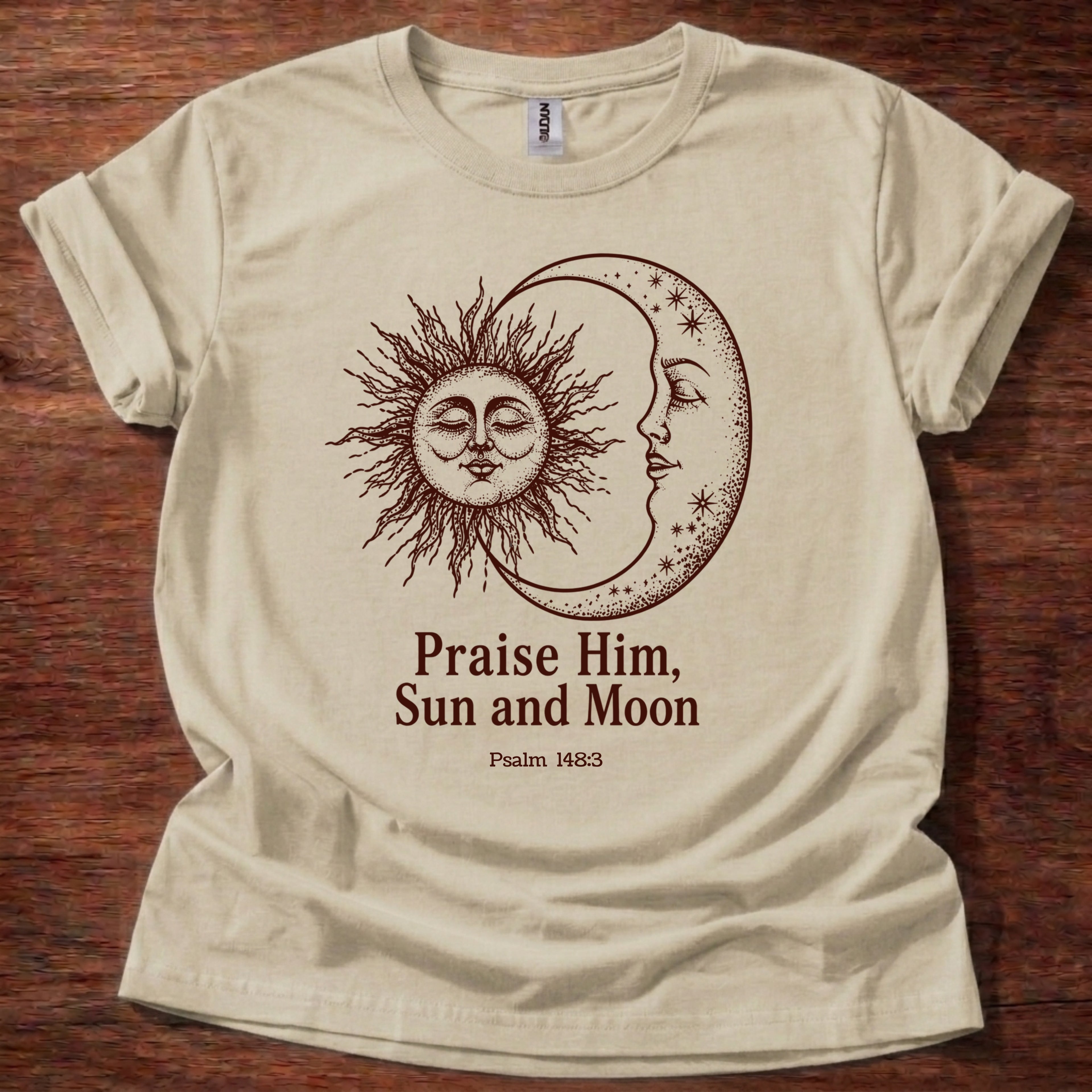 Sand t-shirt featuring a sun and moon celestial design with the text “Praise Him, Sun and Moon Psalm 148:3” printed on the front