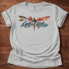 Sport Grey t-shirt featuring a colorful watercolor dragonfly design with the words “God is Good” printed across the front