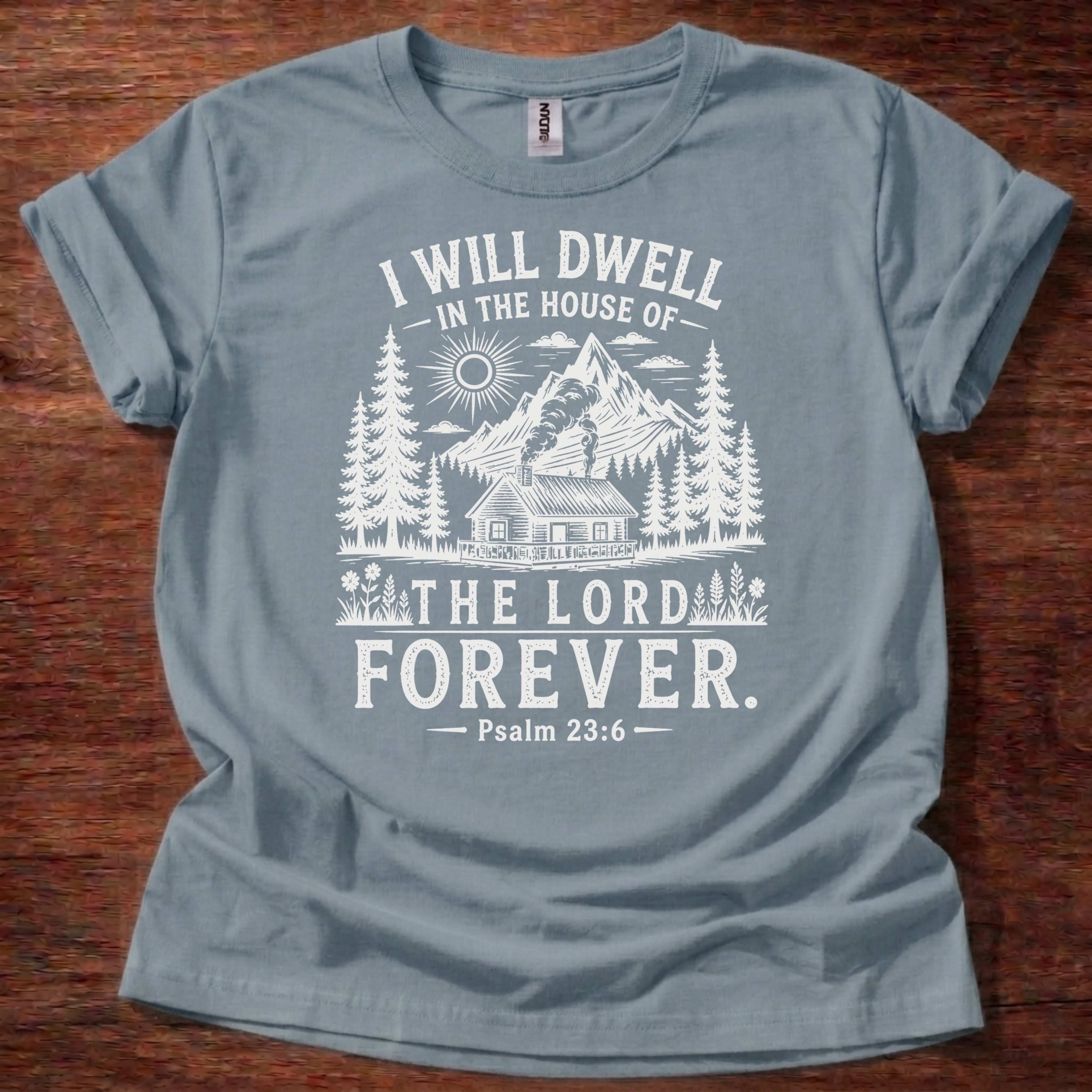 Stone Blue Christian t-shirt with rustic mountain forest design and “I will dwell in the house of the Lord forever” Psalm 23:6 text