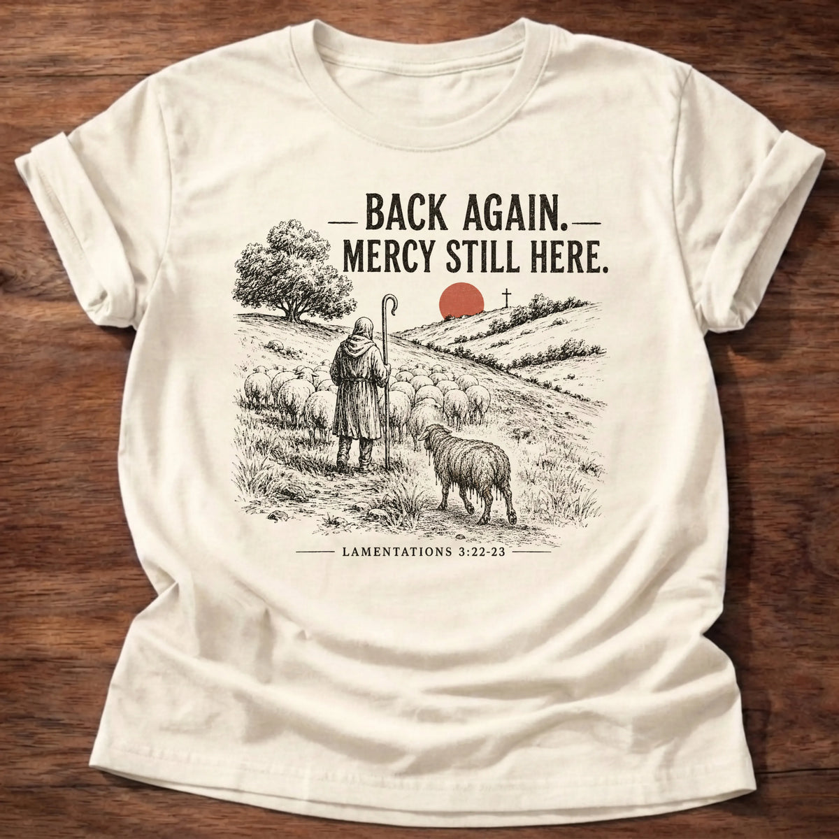 Natural Gildan 64000 t-shirt with a shepherd and sheep illustration and 'Back Again, Mercy Still Here' text, Lamentations 3:22-23 Christian t-shirt