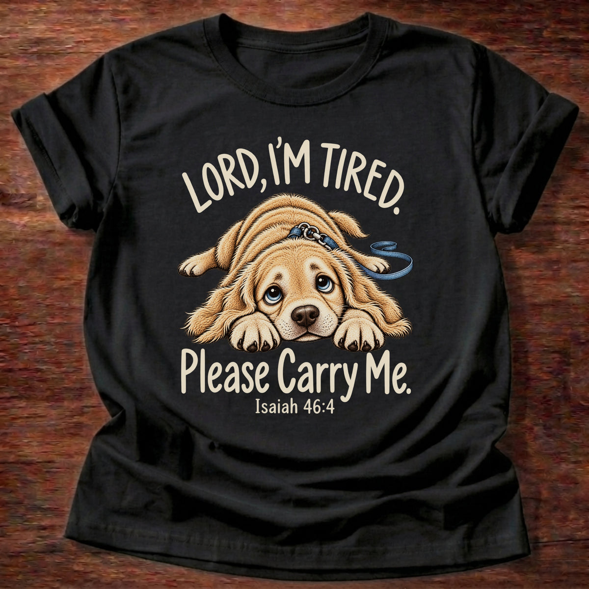 Black t-shirt printed with a tired puppy lying flat on the floor graphic and “Lord, I'm tired. Please carry me.” Isaiah 46:4 Christian shirt