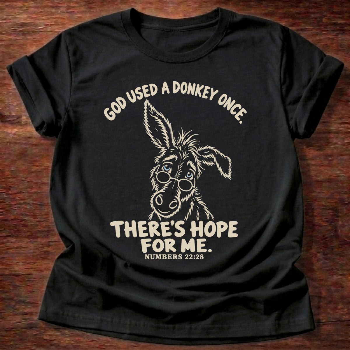 Black t-shirt printed with a hand-drawn donkey and “God used a donkey once. There's hope for me.” Numbers 22:28 Christian shirt