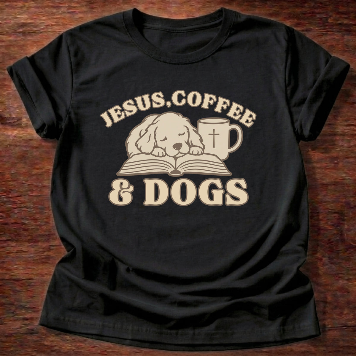 Black t-shirt printed with a sleepy puppy resting on an open Bible beside a coffee mug with a cross and “Jesus, Coffee & Dogs” Christian shirt