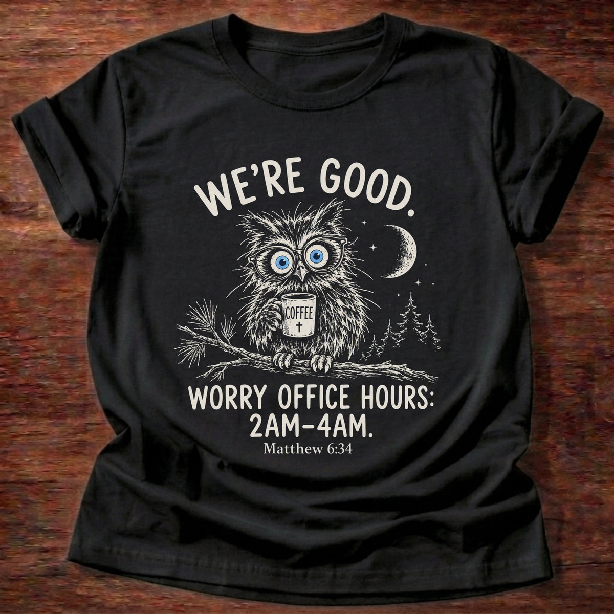 Black t-shirt printed with a wide-eyed owl holding a mug on a moonlit branch graphic and “We're good. Worry office hours: 2AM-4AM.” Matthew 6:34 Christian shirt