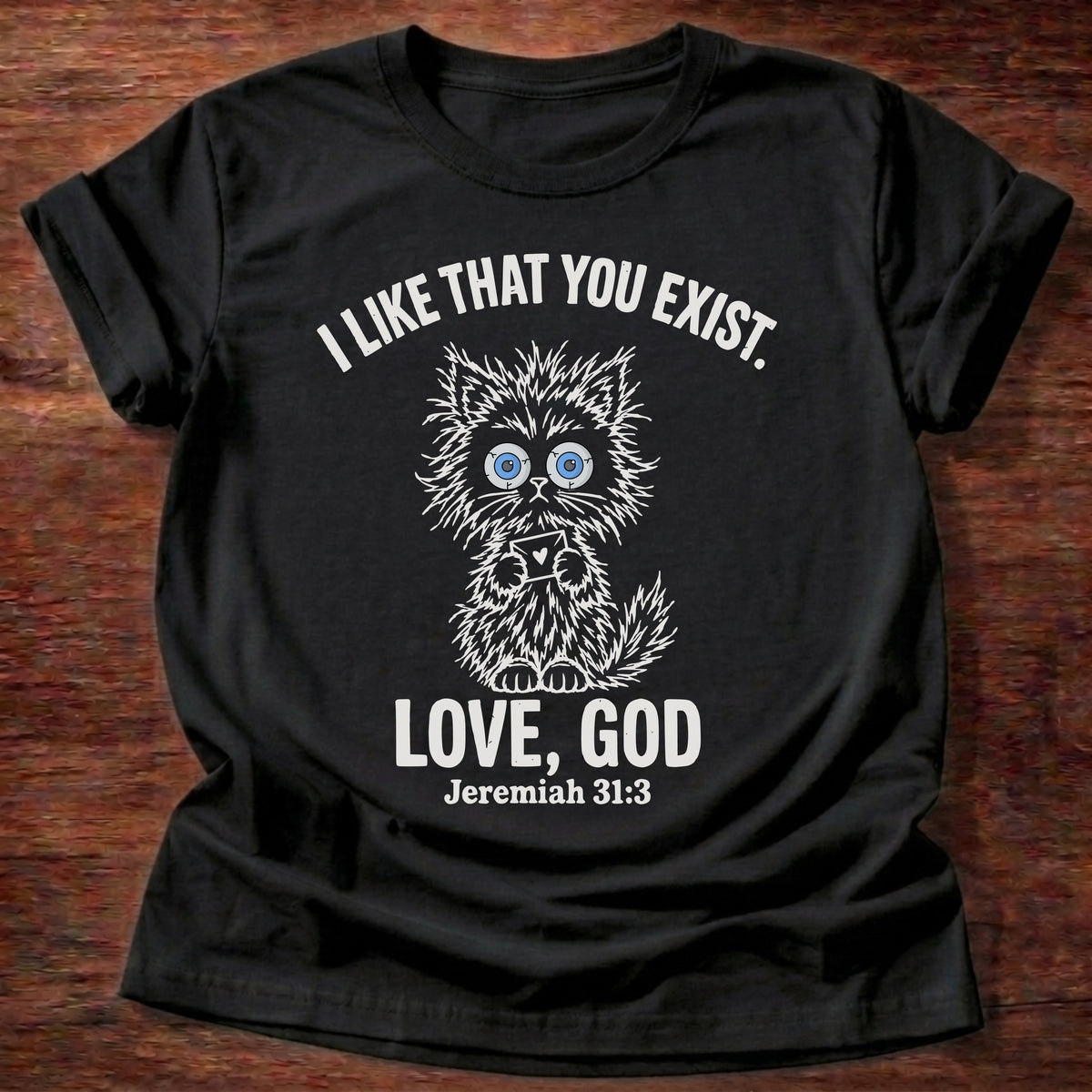 Black t-shirt printed with a fluffy wide-eyed kitten graphic and “I like that you exist. Love, God.” Jeremiah 31:3 Christian shirt