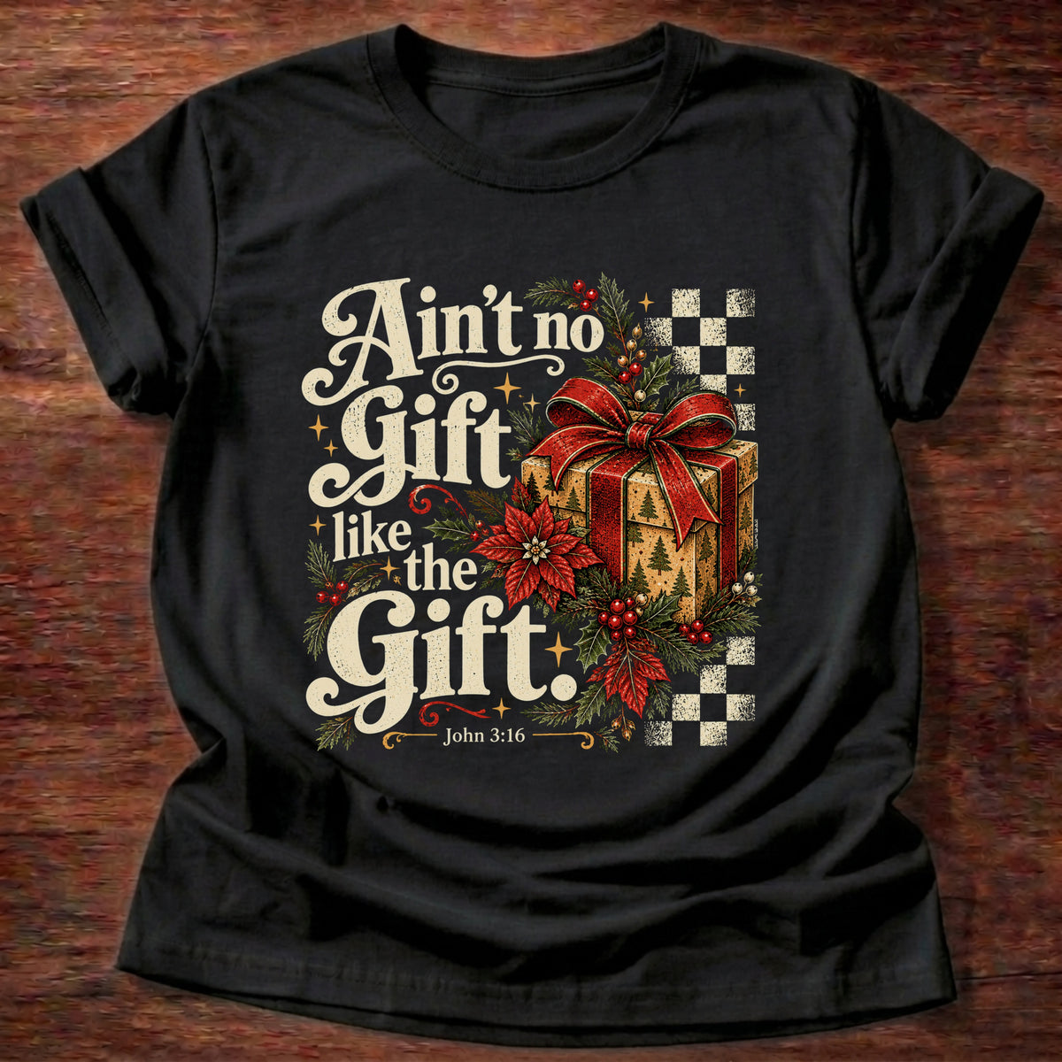 Black t-shirt printed with a retro wrapped Christmas present with poinsettias and checkerboard graphic and “Ain't no Gift like the Gift.” John 3:16 Christian shirt