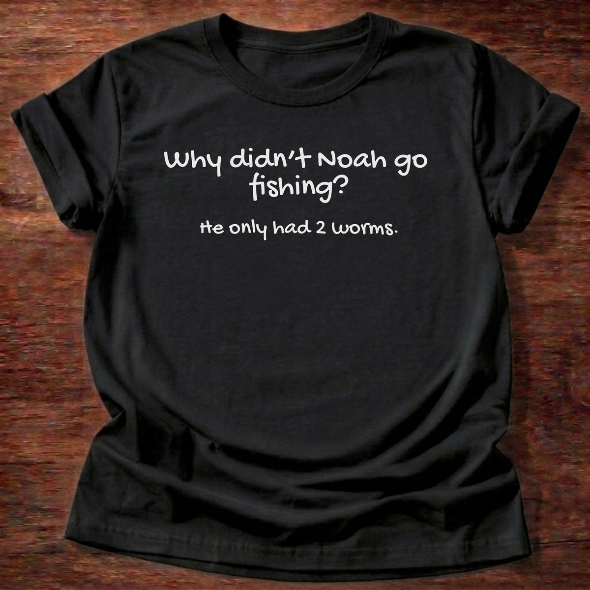 Black t-shirt printed with a simple hand-lettered Bible joke graphic and “Why didn't Noah go fishing? He only had 2 worms.” Genesis 7:9 Christian shirt