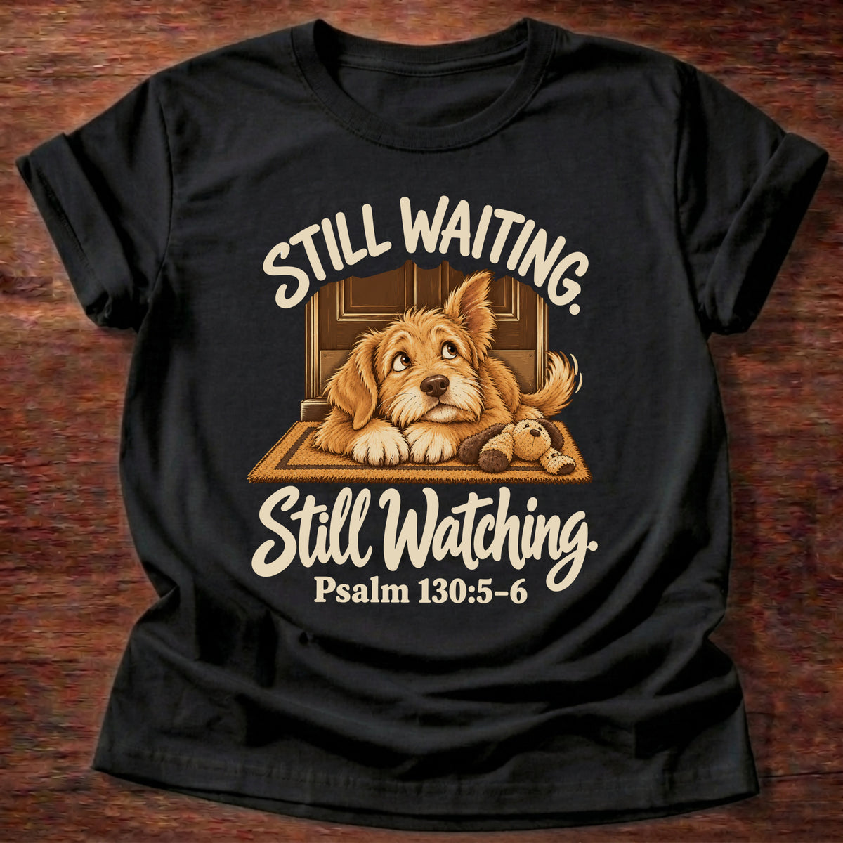 Black t-shirt printed with a puppy lying on a doormat waiting at the door and “Still waiting. Still watching.” Psalm 130:5-6 Christian shirt