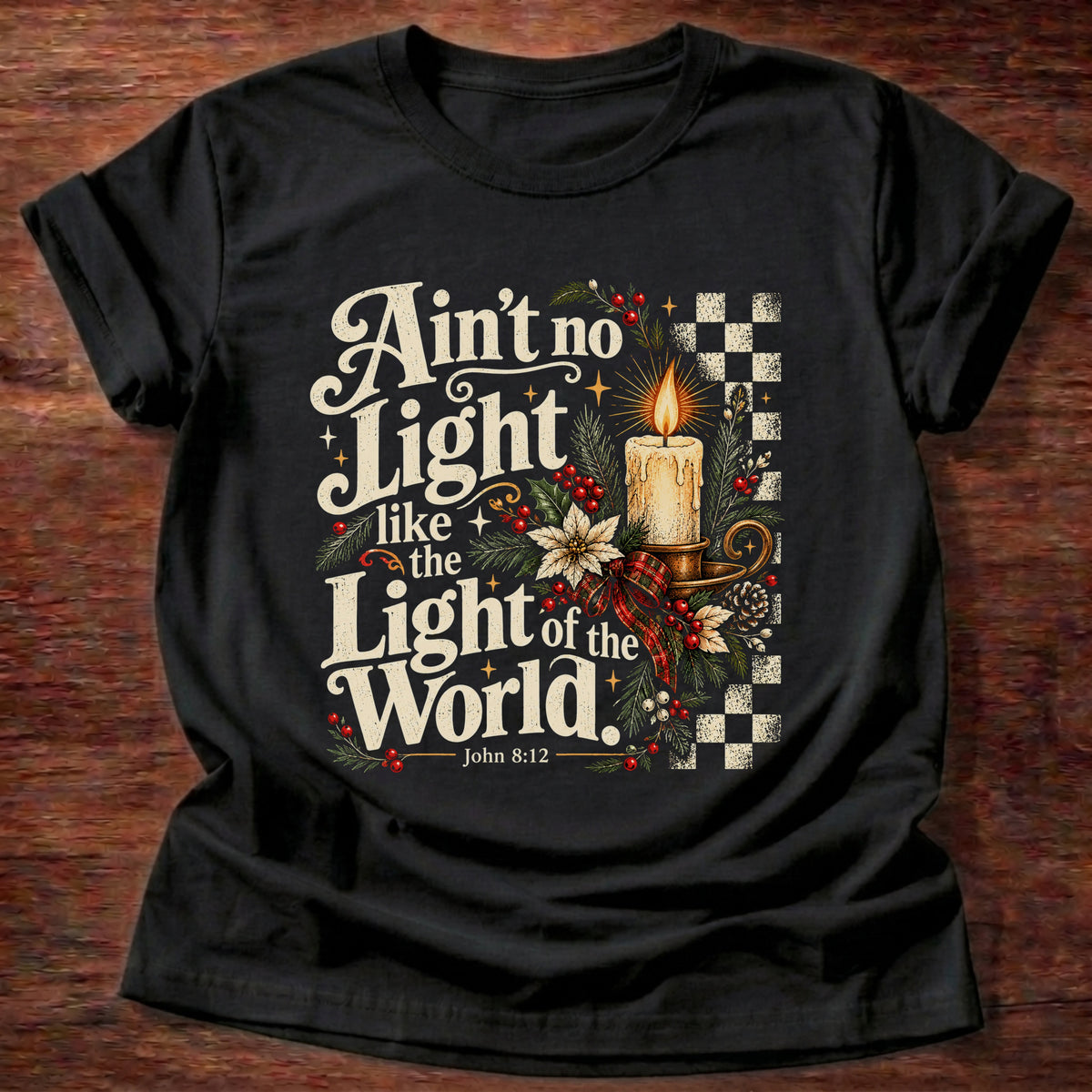 Black t-shirt printed with a retro glowing candle with poinsettias and checkerboard graphic and “Ain't no light like the Light of the World.” John 8:12 Christian shirt