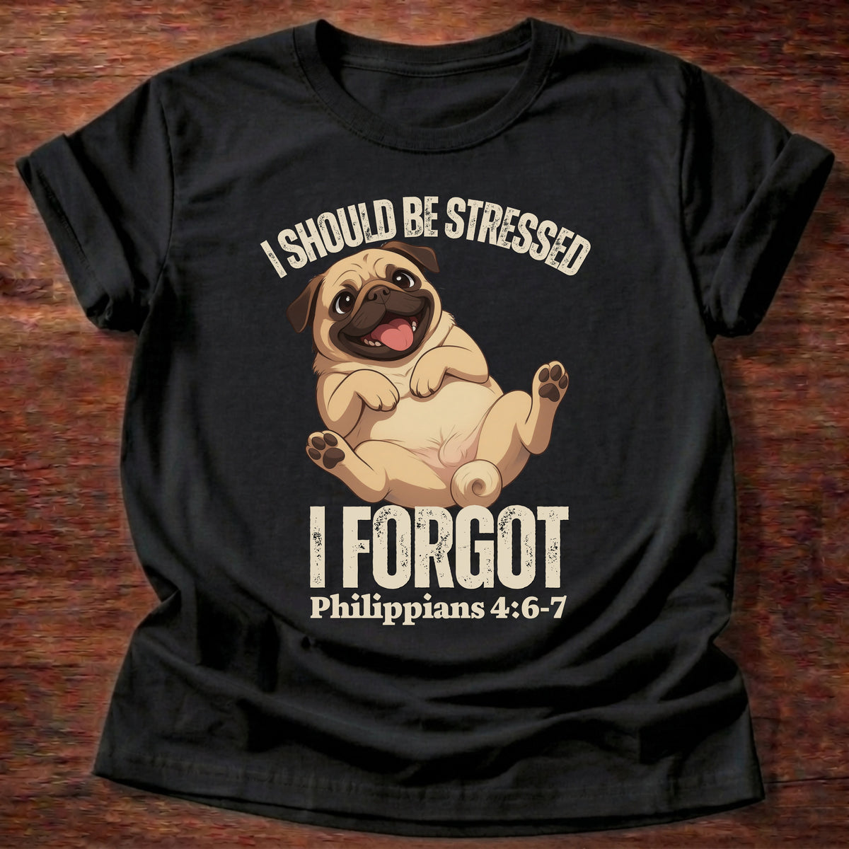 Black t-shirt printed with a relaxed pug lying on its back and “I should be stressed. I forgot.” Philippians 4:6-7 Christian shirt