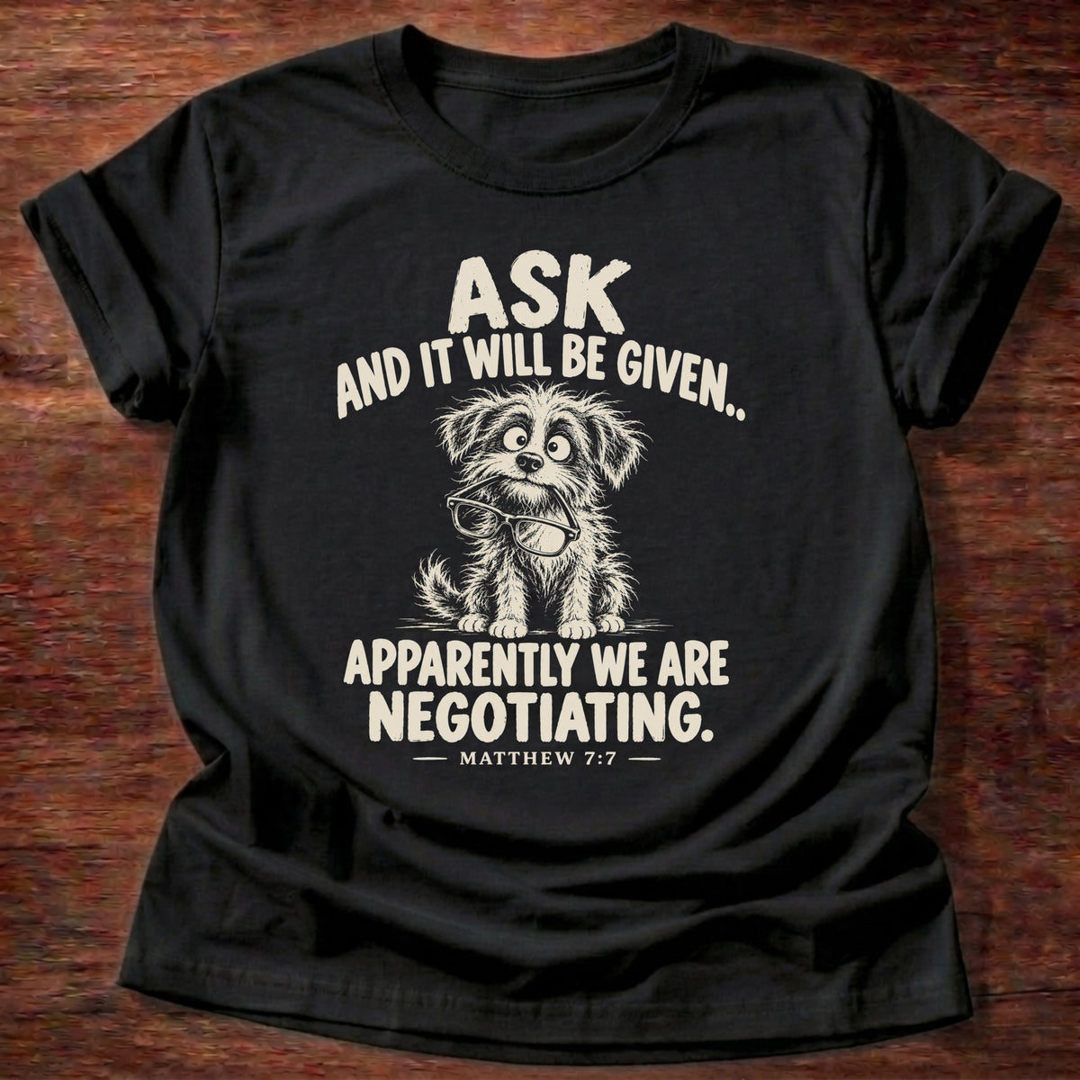 Ask T-Shirt in Black featuring a scruffy wide-eyed puppy and Matthew 7:7 prayer humor design