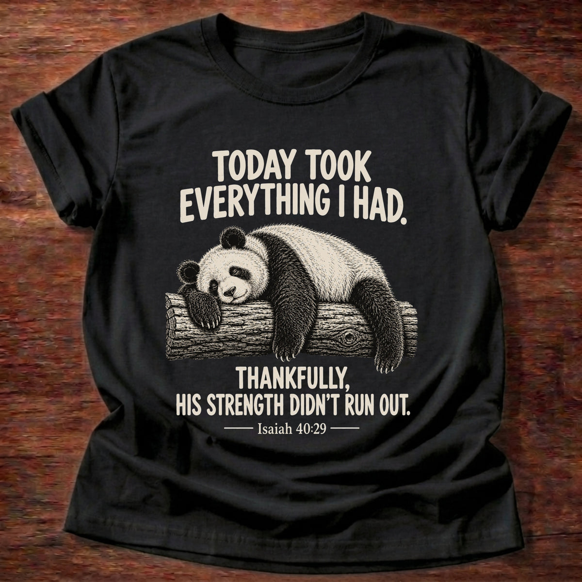 Black t-shirt printed with a panda sleeping draped over a log graphic and “Today took everything I had. Thankfully, His strength didn't run out.” Isaiah 40:29 faith based gift