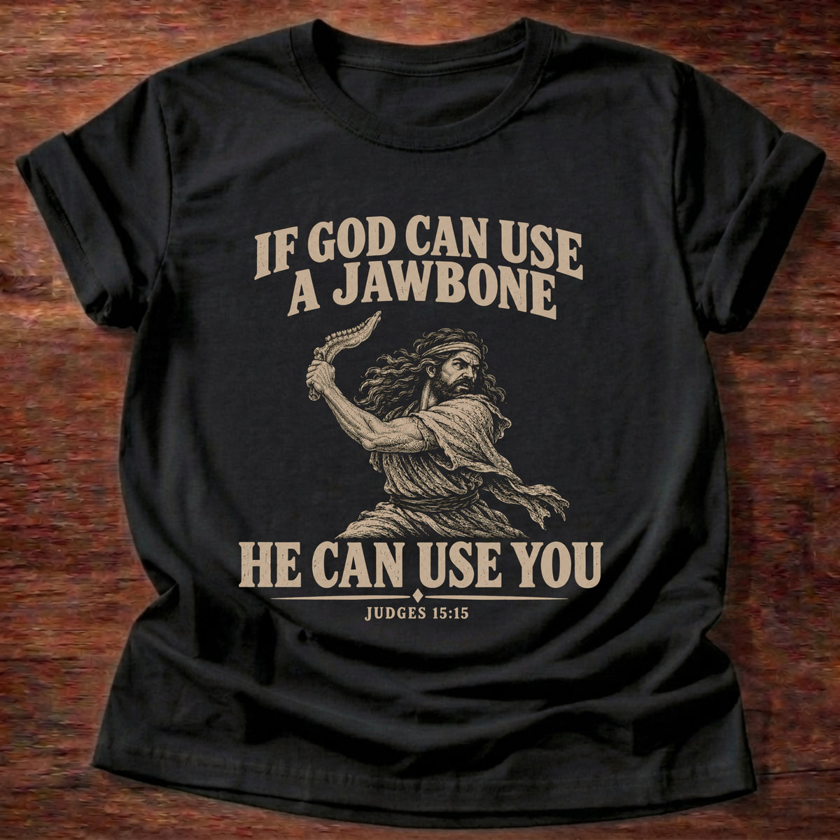 Black t-shirt printed with Samson holding a jawbone graphic and 'If God can use a jawbone, He can use you.' Judges 15:15 faith based gift