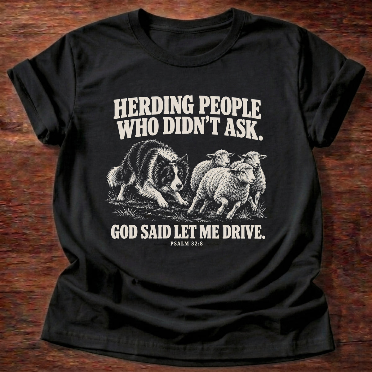 Black t-shirt printed with a border collie herding a flock of sheep graphic and 'Herding people who didn't ask. God said let me drive.' Psalm 32:8 faith based gift